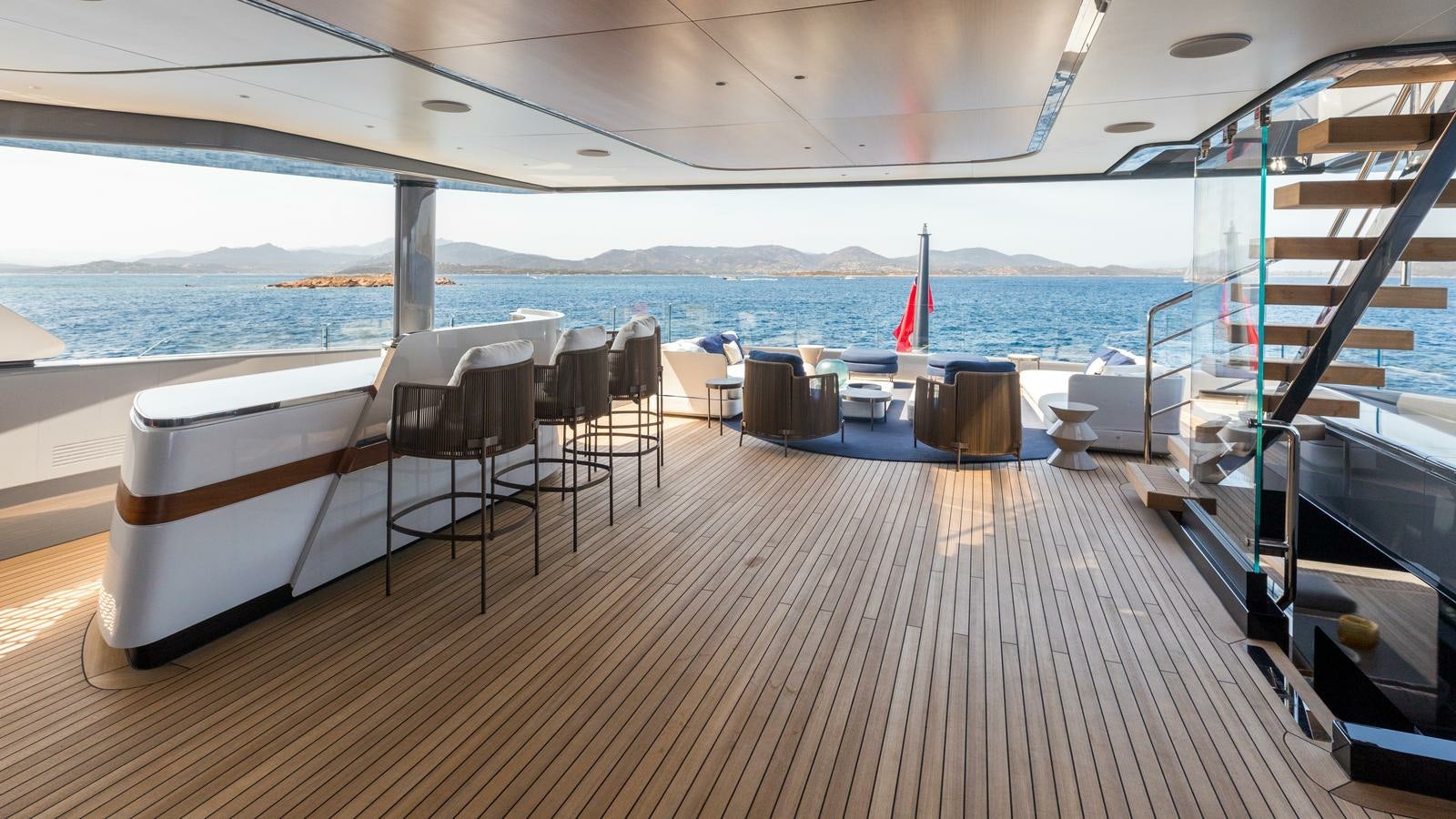 a deck with chairs and tables on it aboard AKULA Yacht for Charter