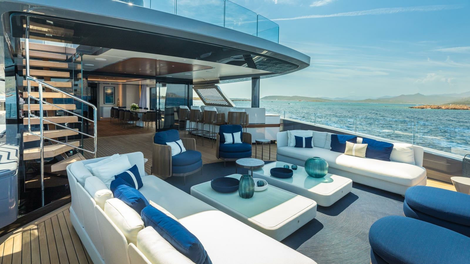 a large living room with a large balcony overlooking the ocean aboard AKULA Yacht for Charter