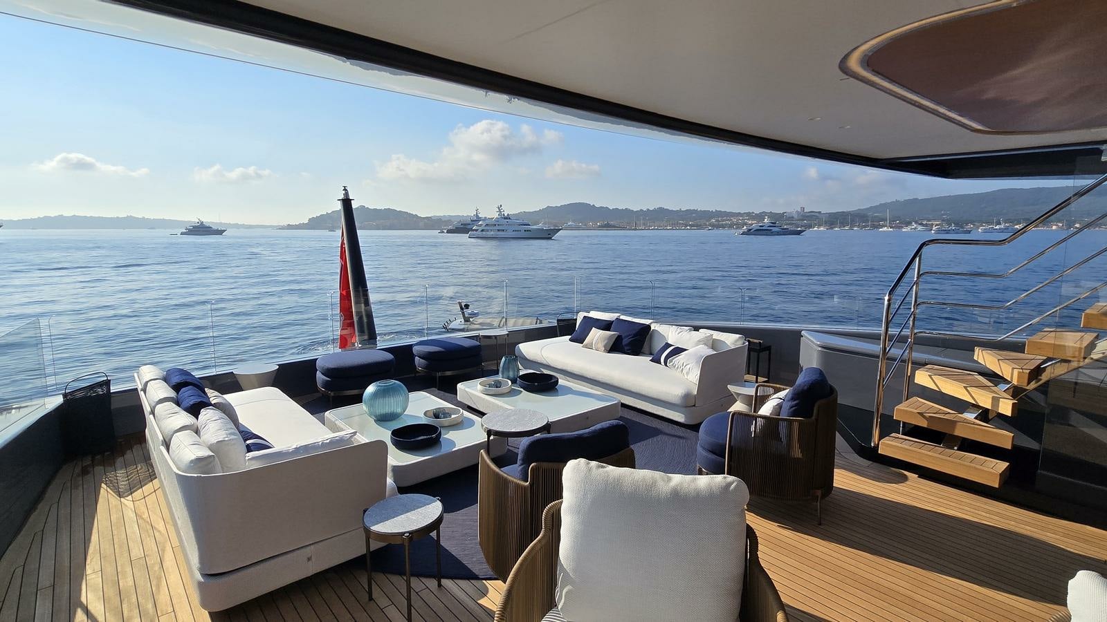 a room with a table chairs and a view of the ocean aboard AKULA Yacht for Charter