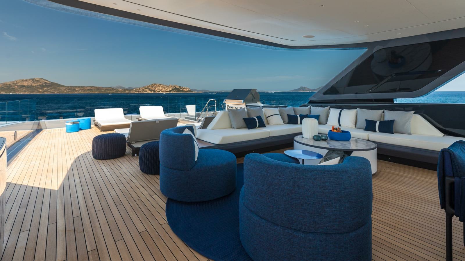 a large lounge area with a large deck and a large body of water aboard AKULA Yacht for Charter