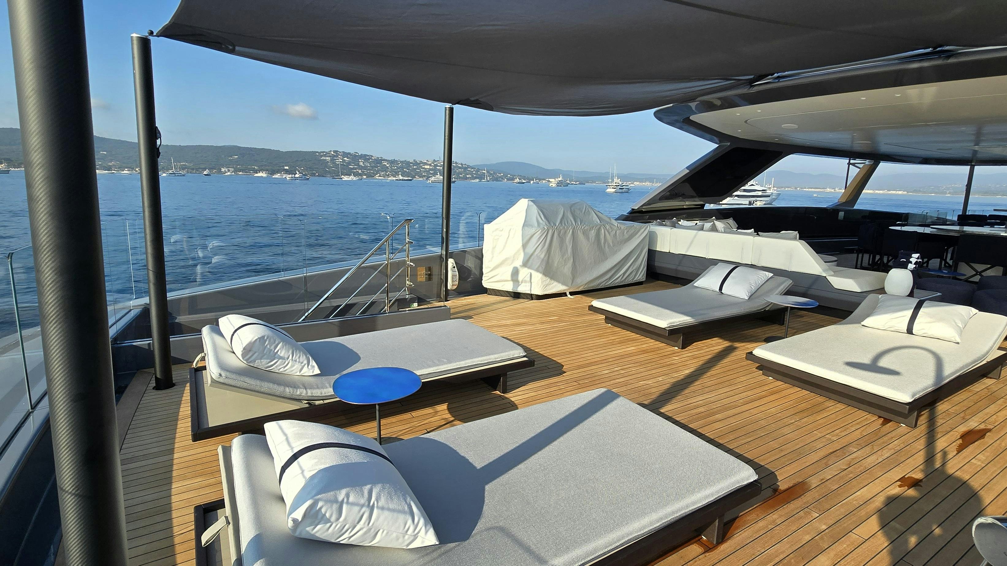 a room with a large bed and a large body of water aboard AKULA Yacht for Charter