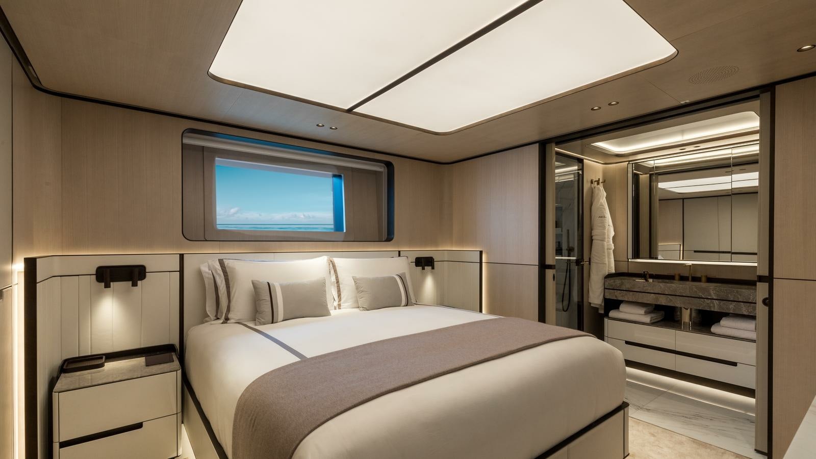 a room with a bed and a television aboard AKULA Yacht for Charter