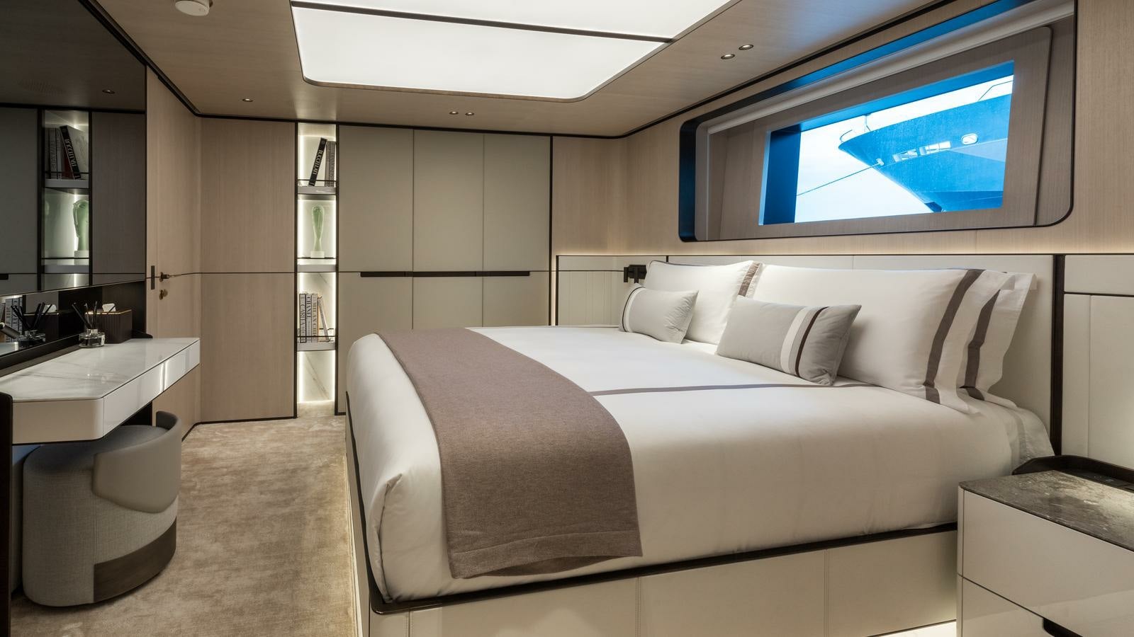 a room with a bed and a desk aboard AKULA Yacht for Charter