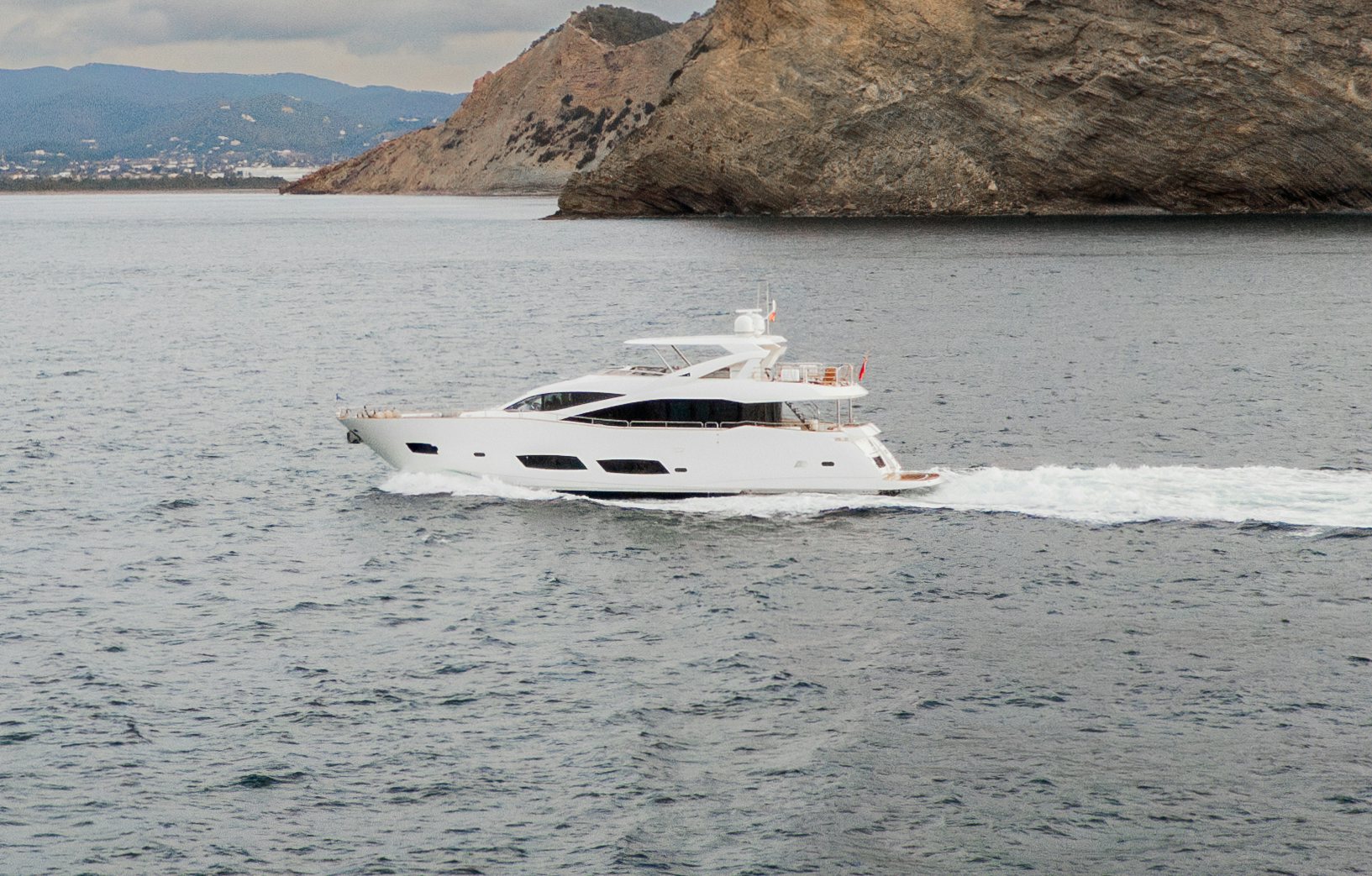 a white boat on the water aboard PLAY THE GAME Yacht for Sale