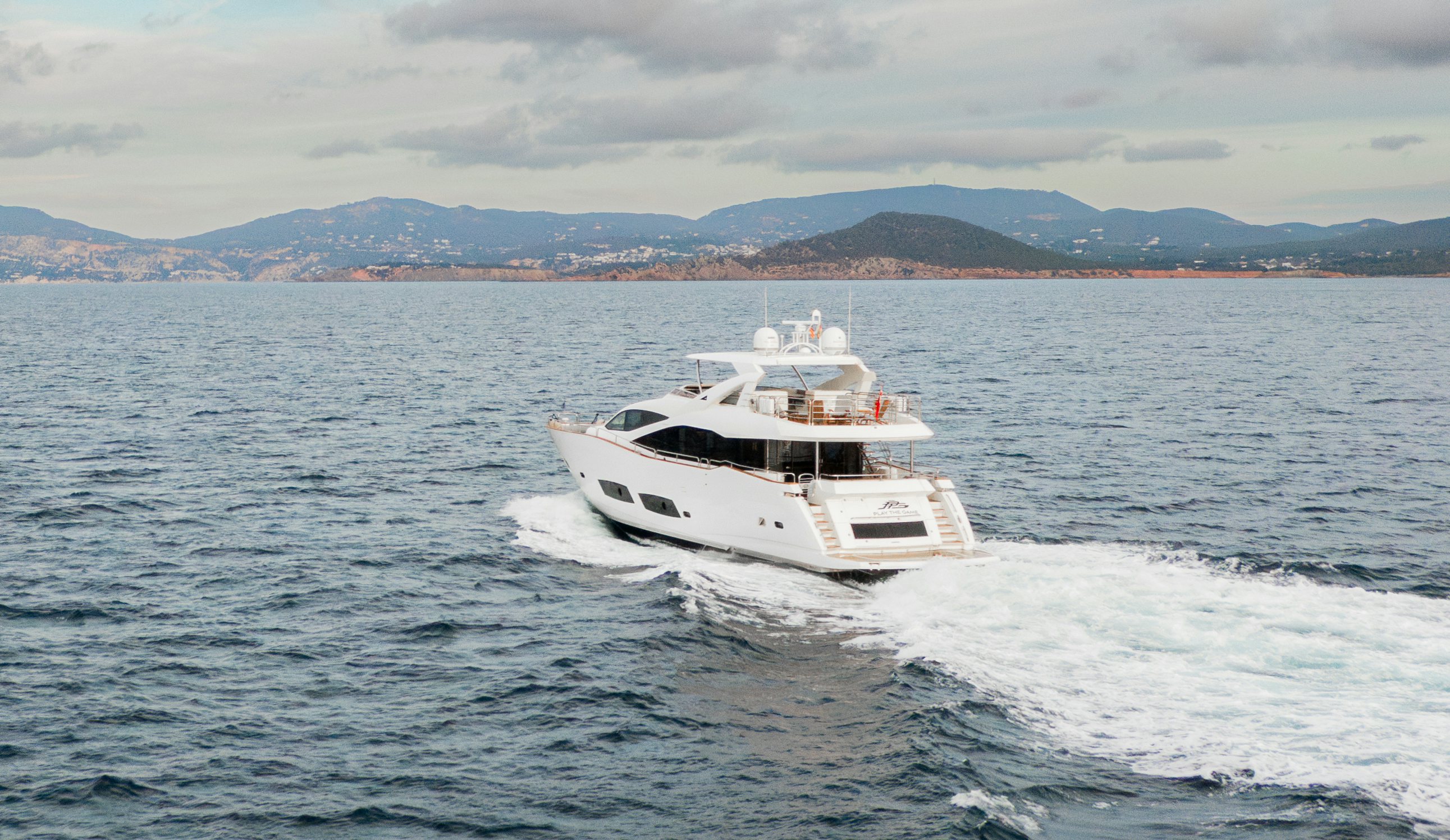 a white yacht on the water aboard PLAY THE GAME Yacht for Sale