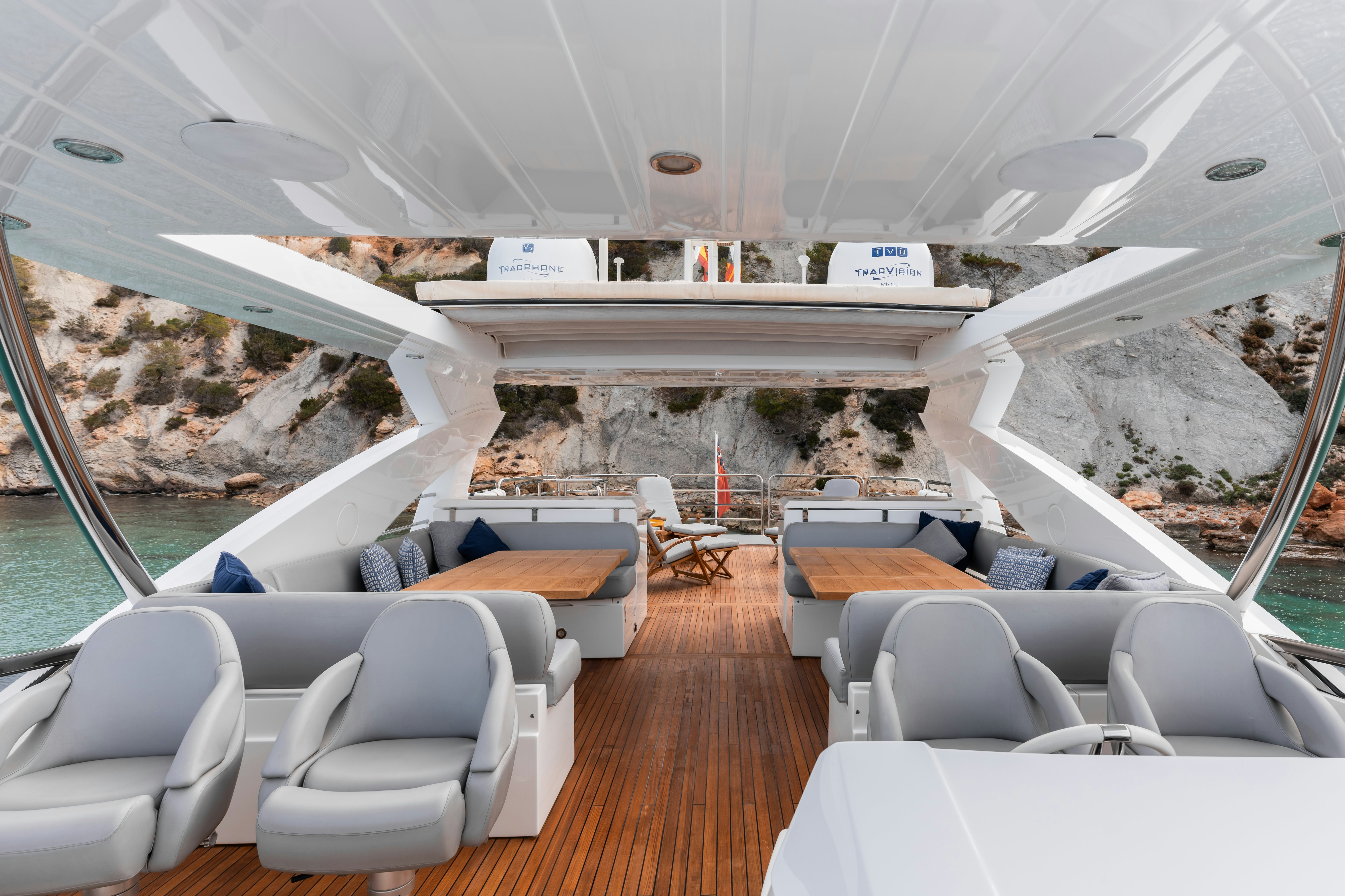 a room with a wood floor and a large window with a view of the city below aboard PLAY THE GAME Yacht for Sale
