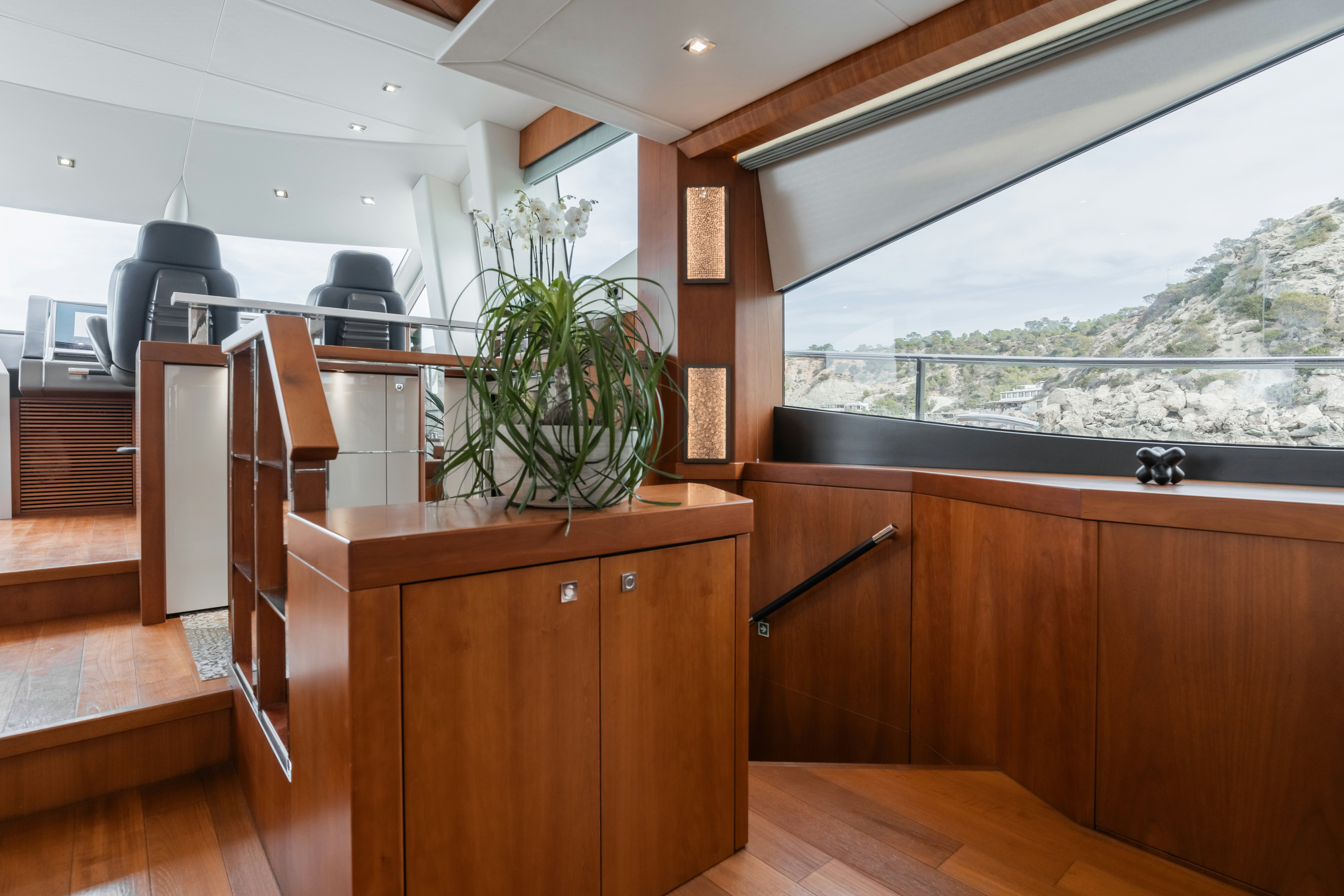 a room with a plant on the wall and a desk with a chair aboard PLAY THE GAME Yacht for Sale