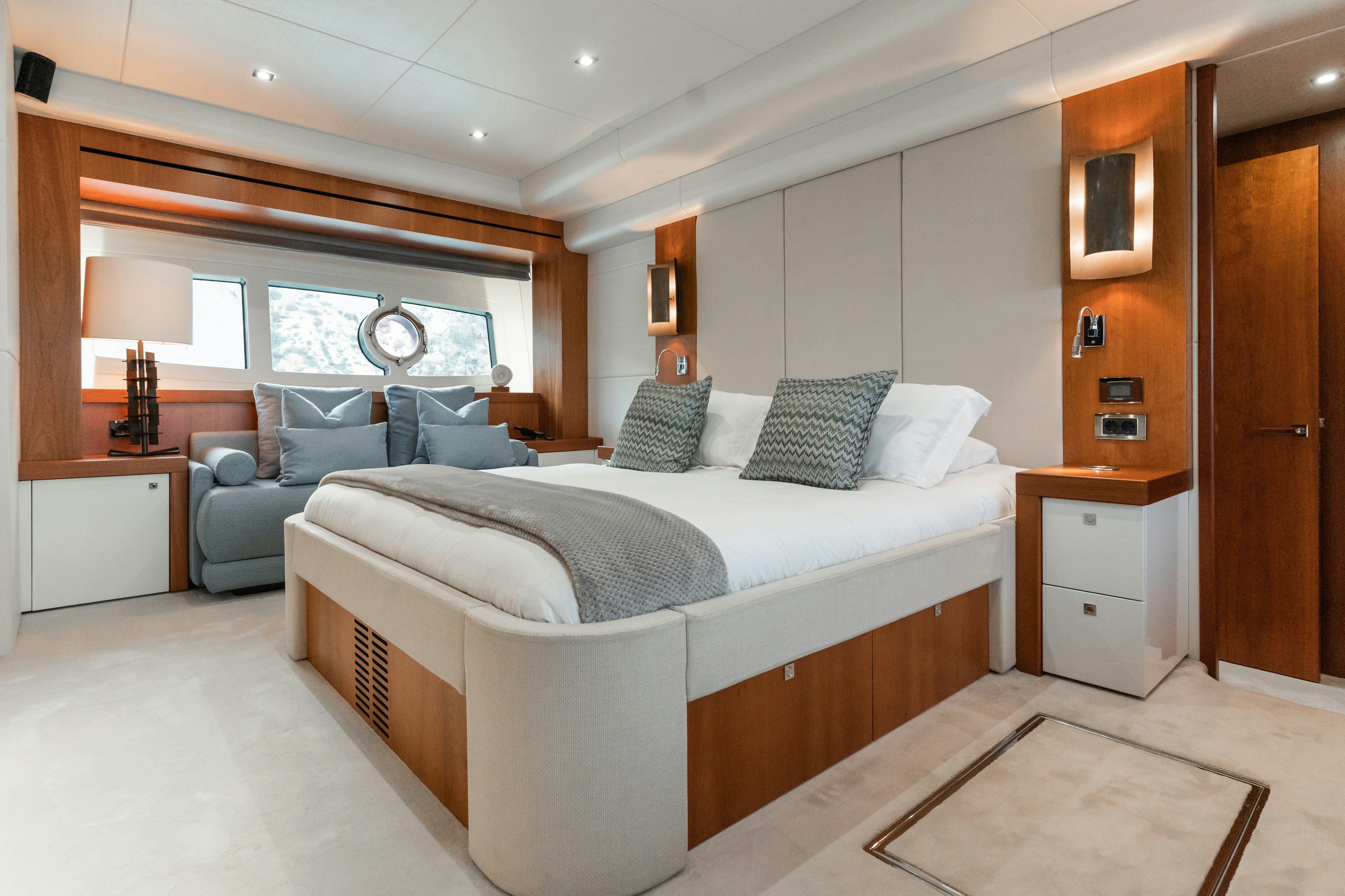 a bedroom with a bed and a couch aboard PLAY THE GAME Yacht for Sale