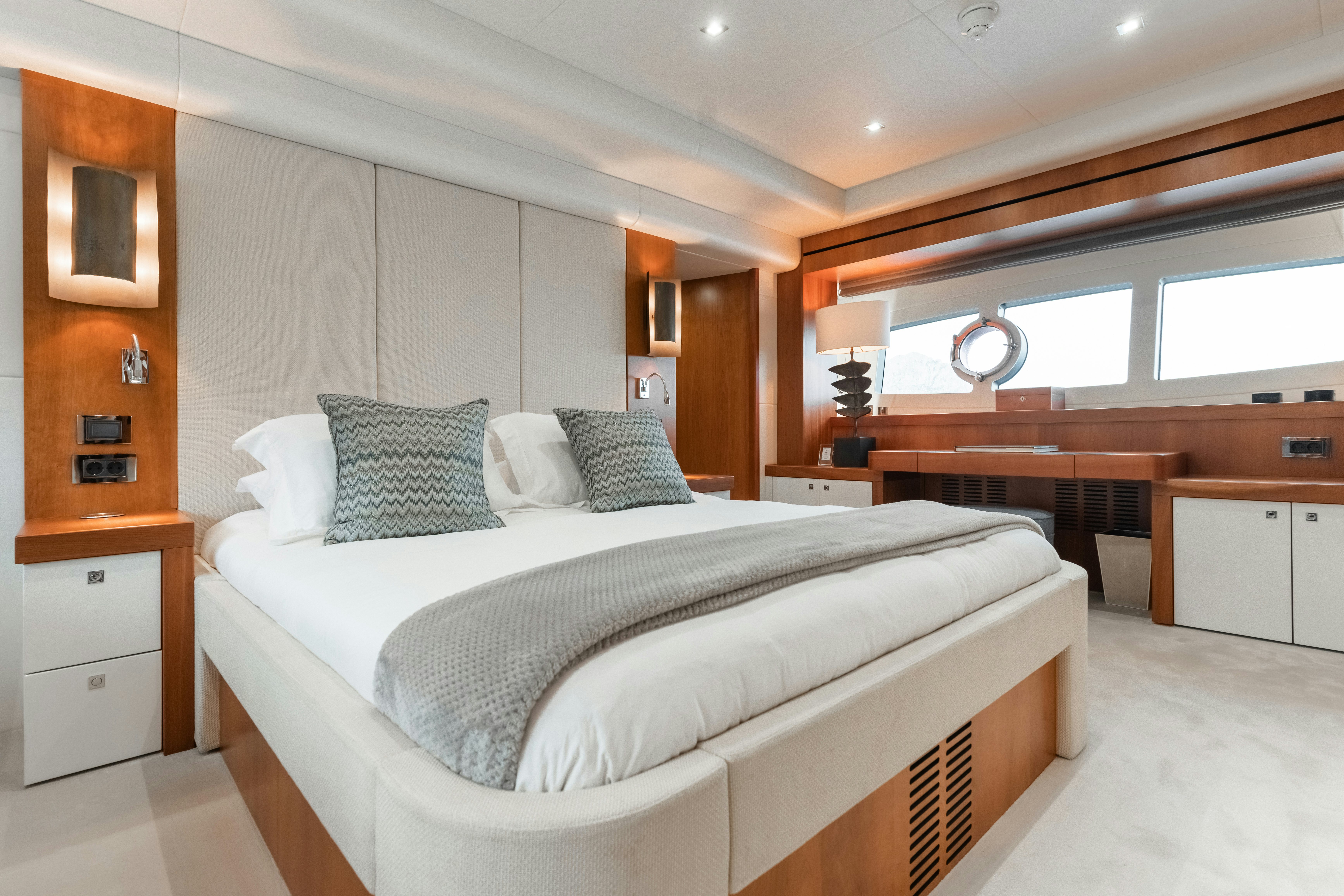 a bedroom with a bed and a mirror aboard PLAY THE GAME Yacht for Sale