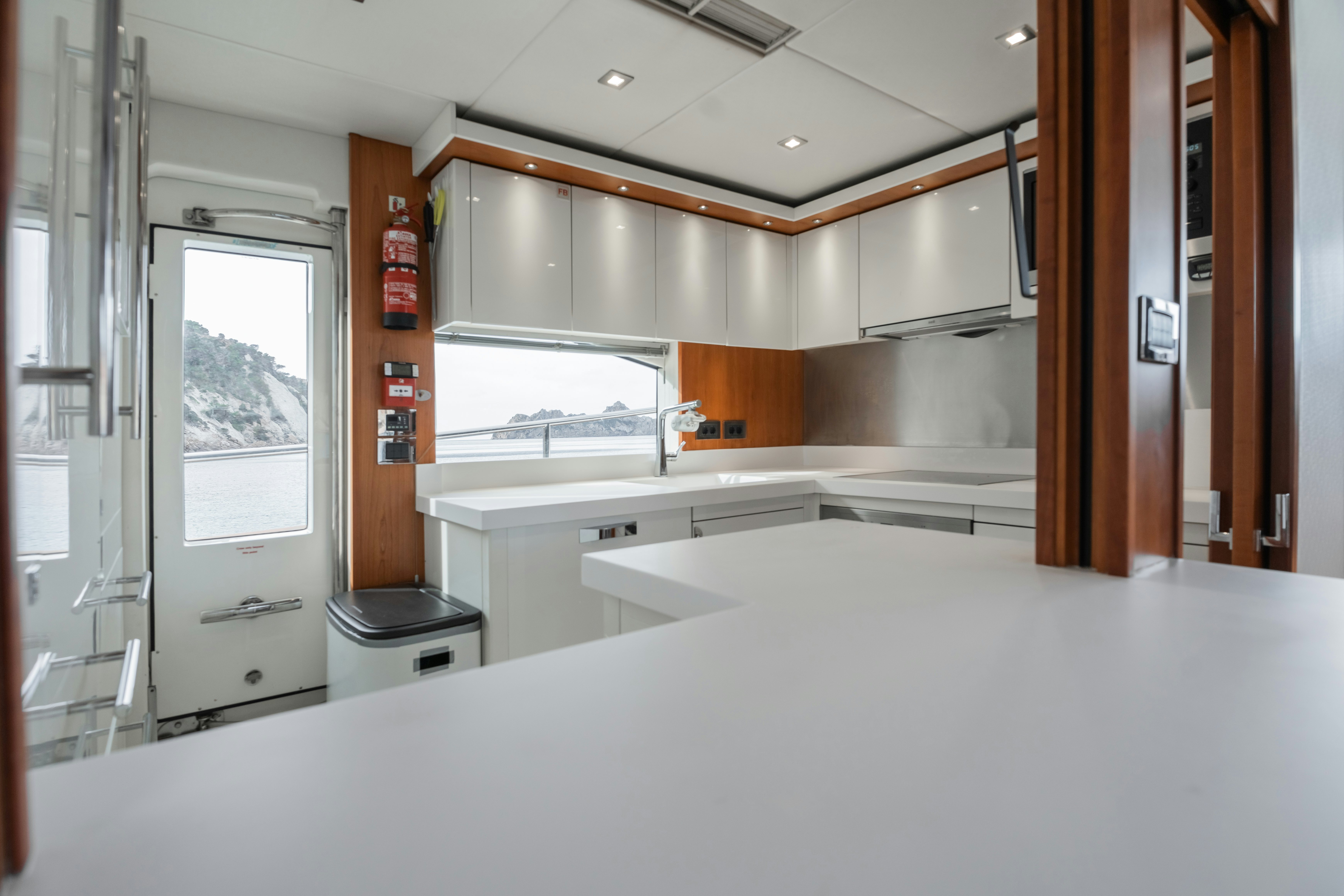 a large kitchen with a large window aboard PLAY THE GAME Yacht for Sale
