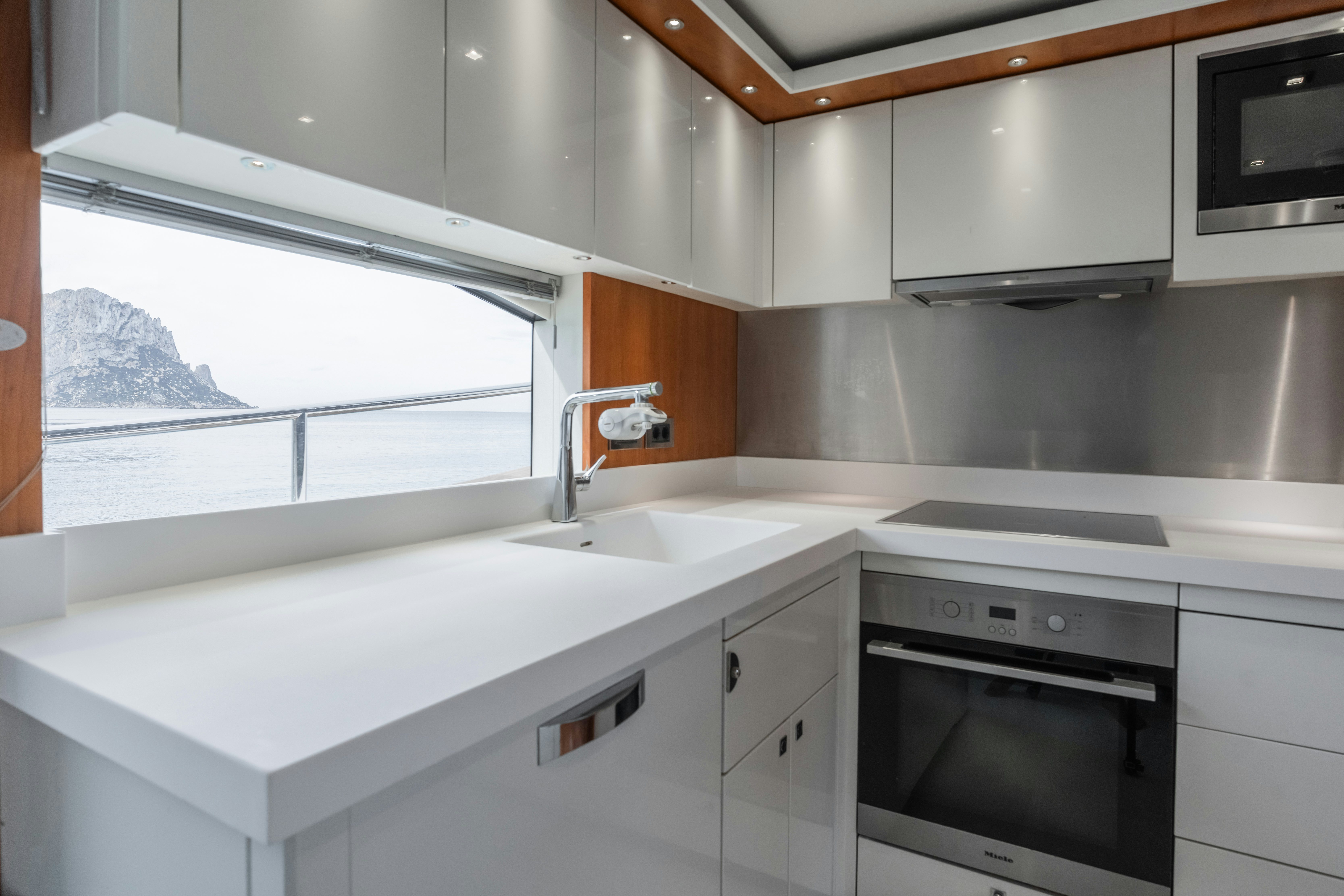 a kitchen with white cabinets aboard PLAY THE GAME Yacht for Sale