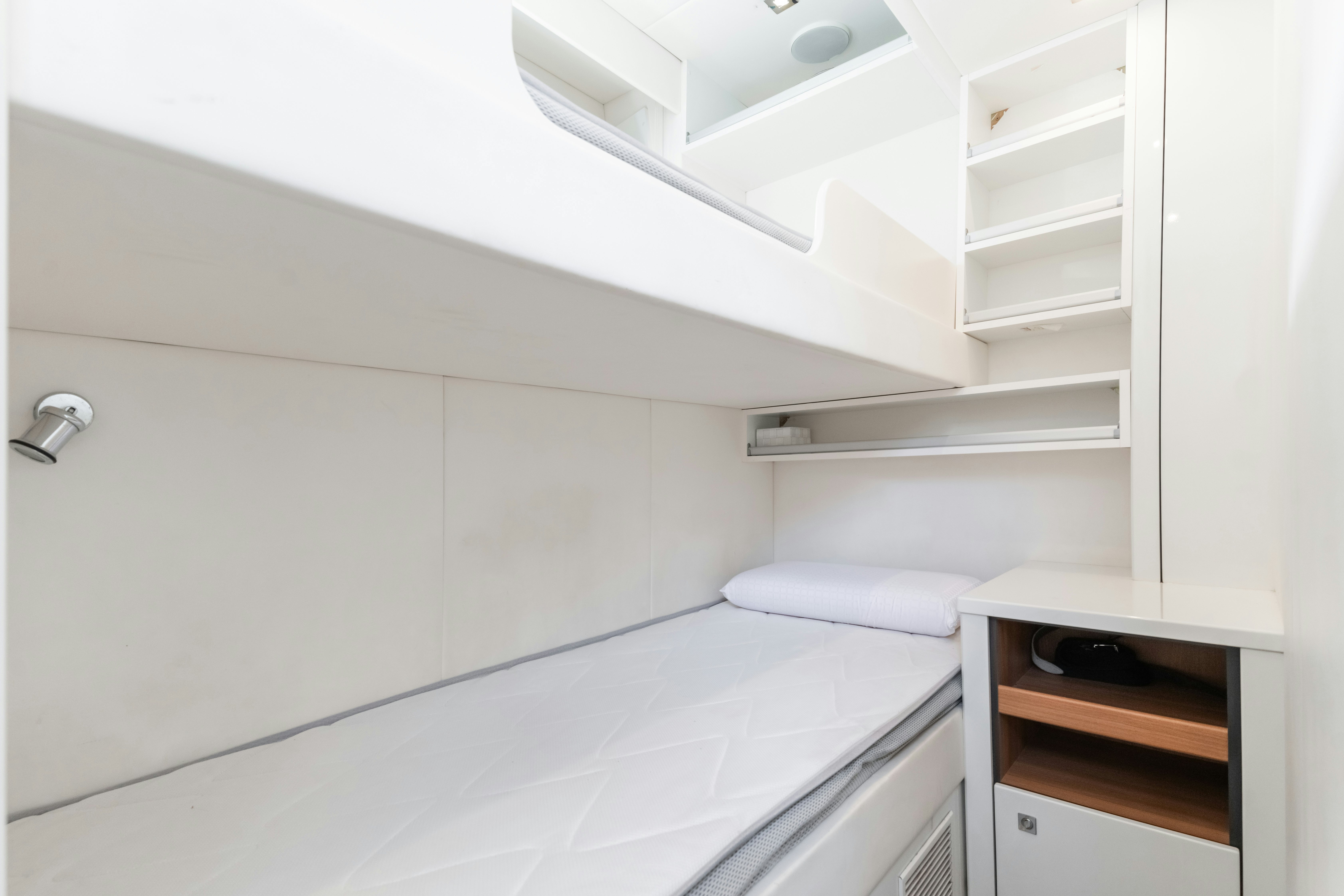 a white room with a shelf and a shelf with a white shelf aboard PLAY THE GAME Yacht for Sale