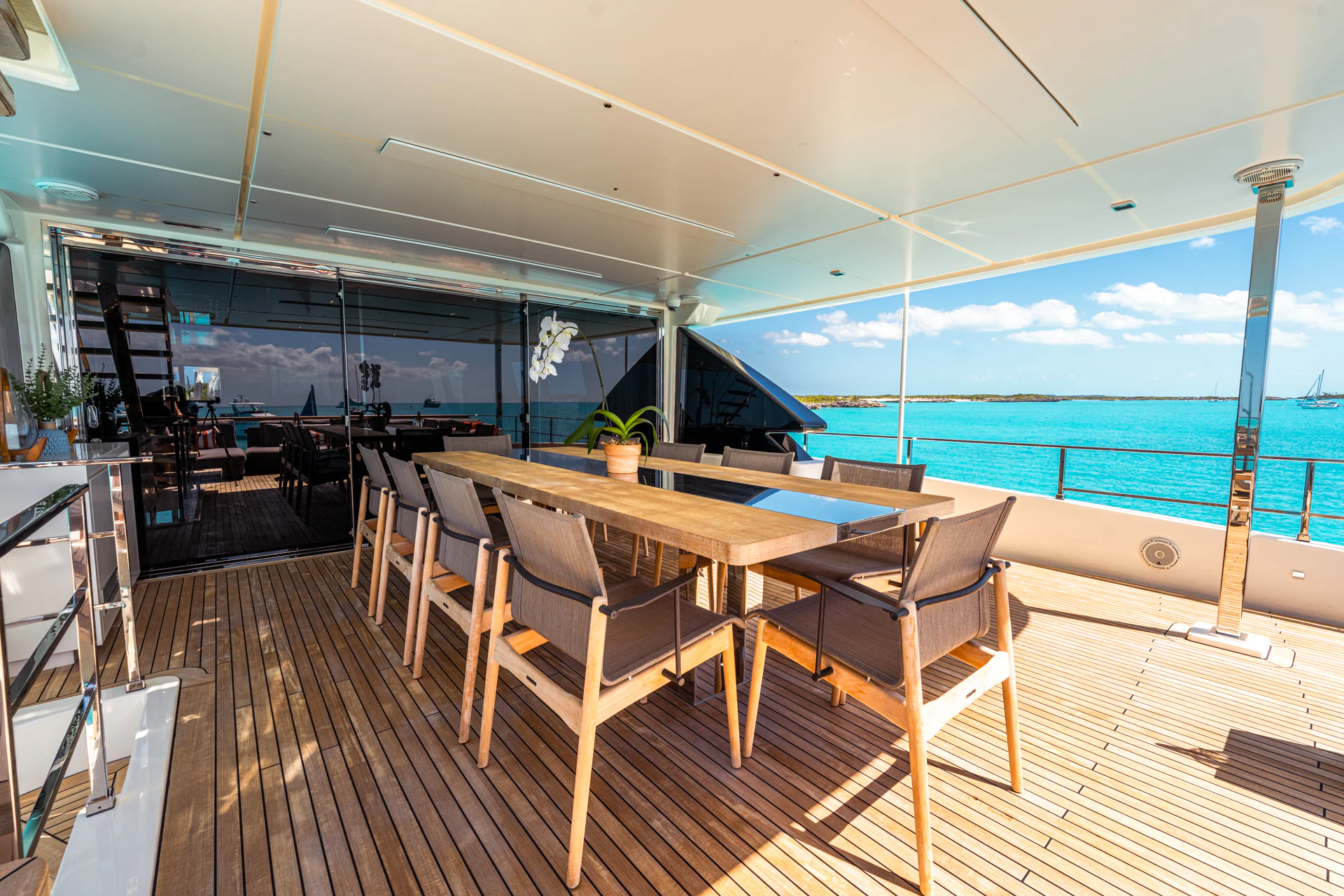 a deck with a table and chairs aboard FIFI Yacht for Charter
