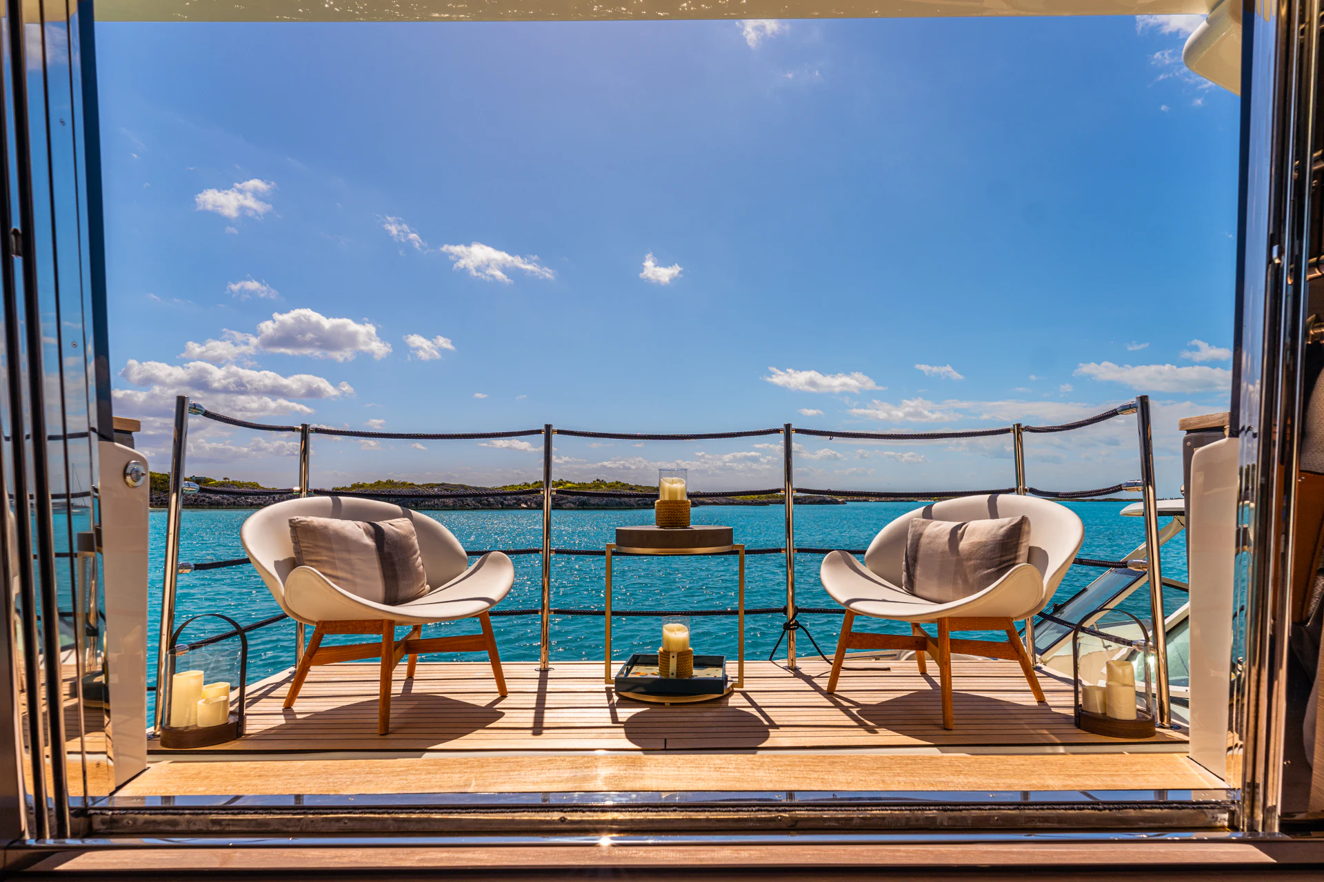 a deck with chairs and a table on it aboard FIFI Yacht for Charter