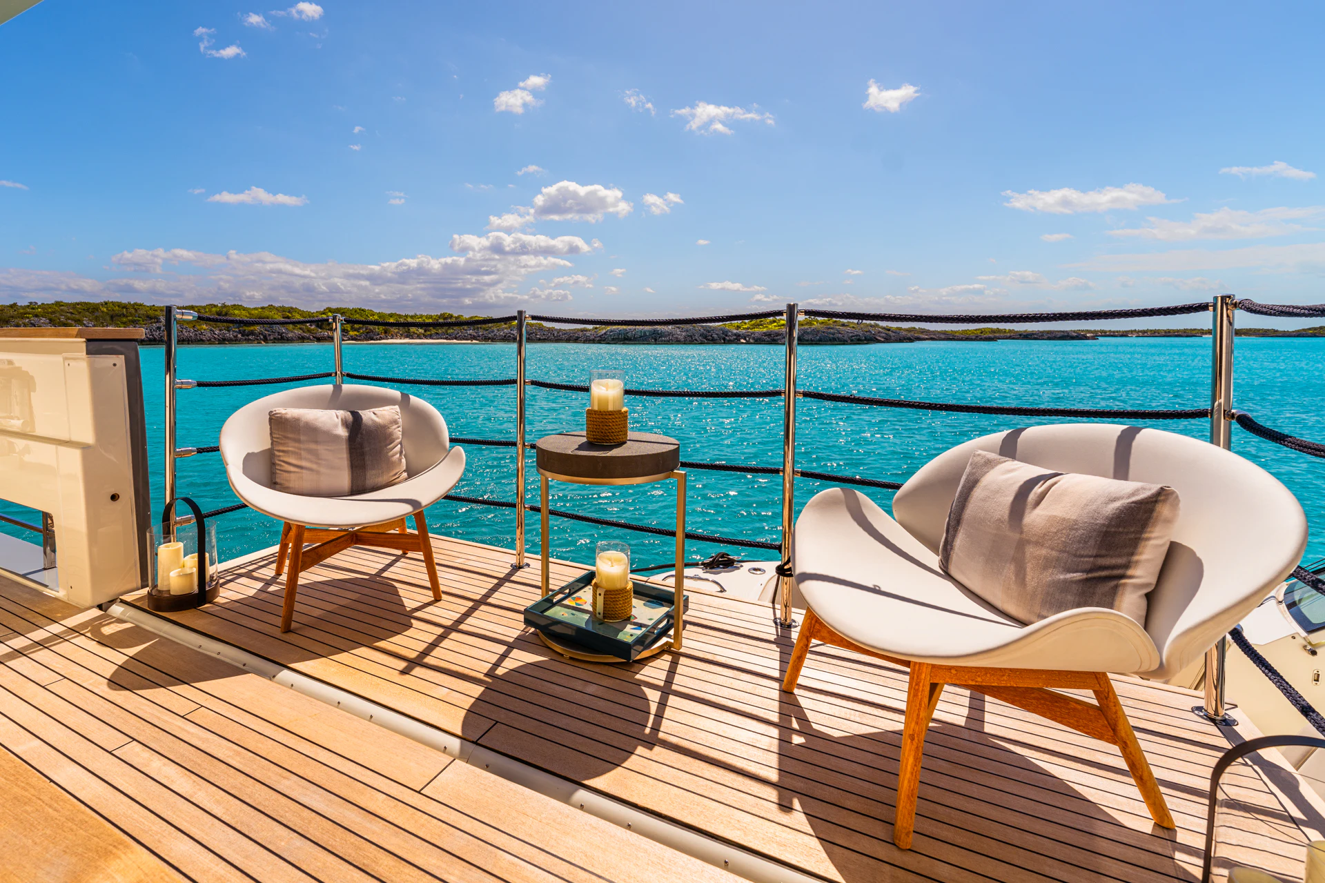 a deck with chairs and a table on it aboard FIFI Yacht for Charter