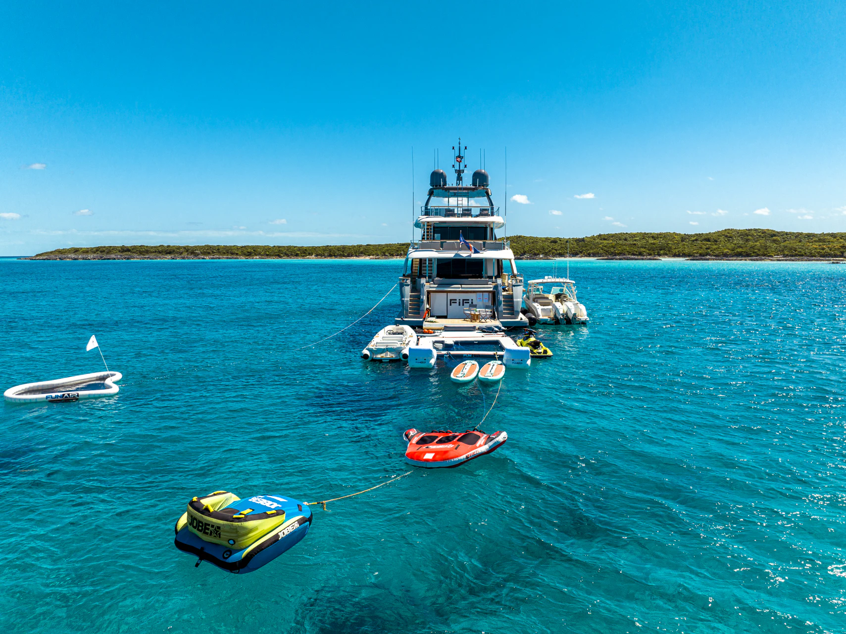 a boat and several boats in the water aboard FIFI Yacht for Charter