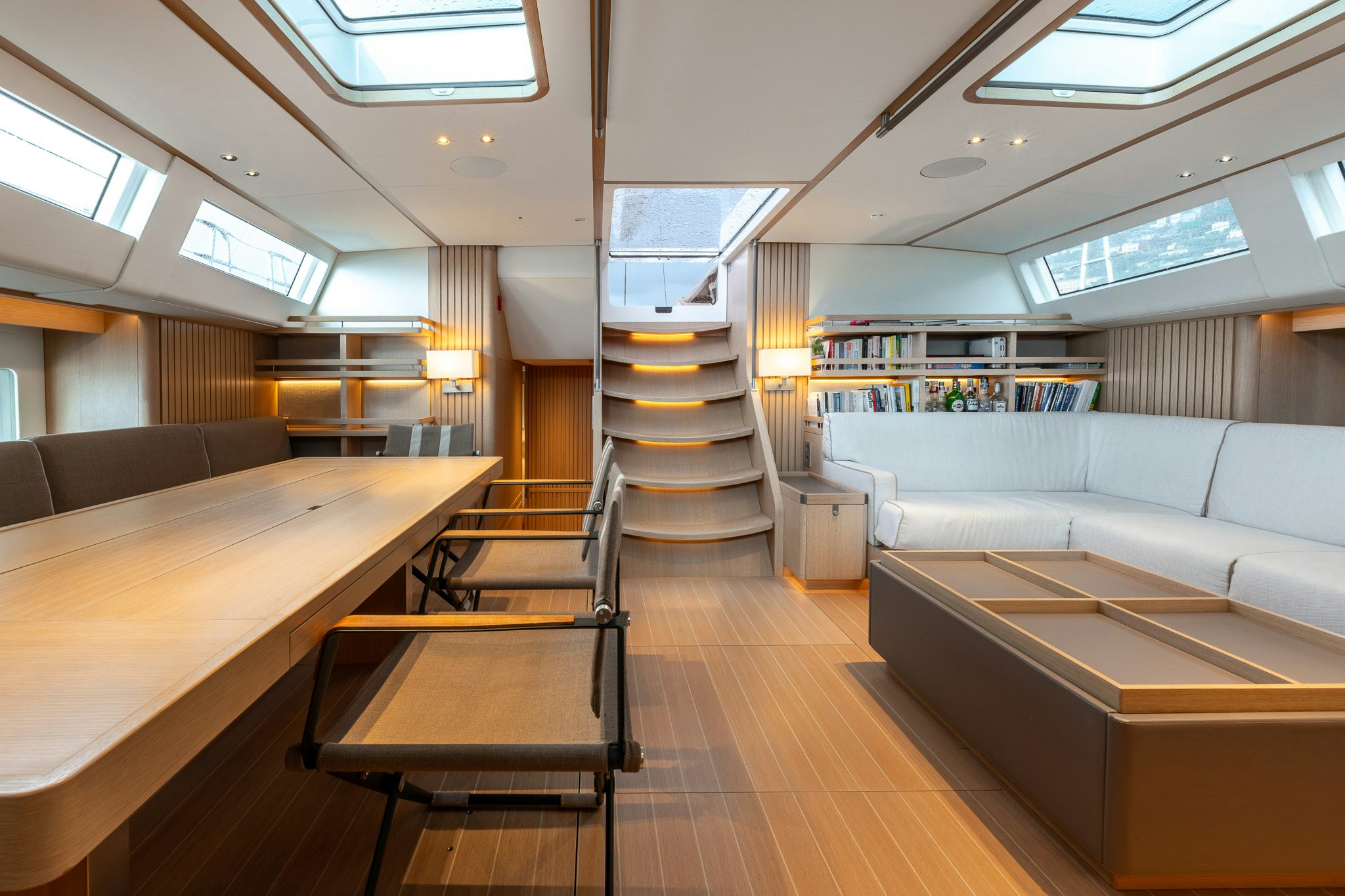 a room with a staircase and couches aboard ALIX Yacht for Sale