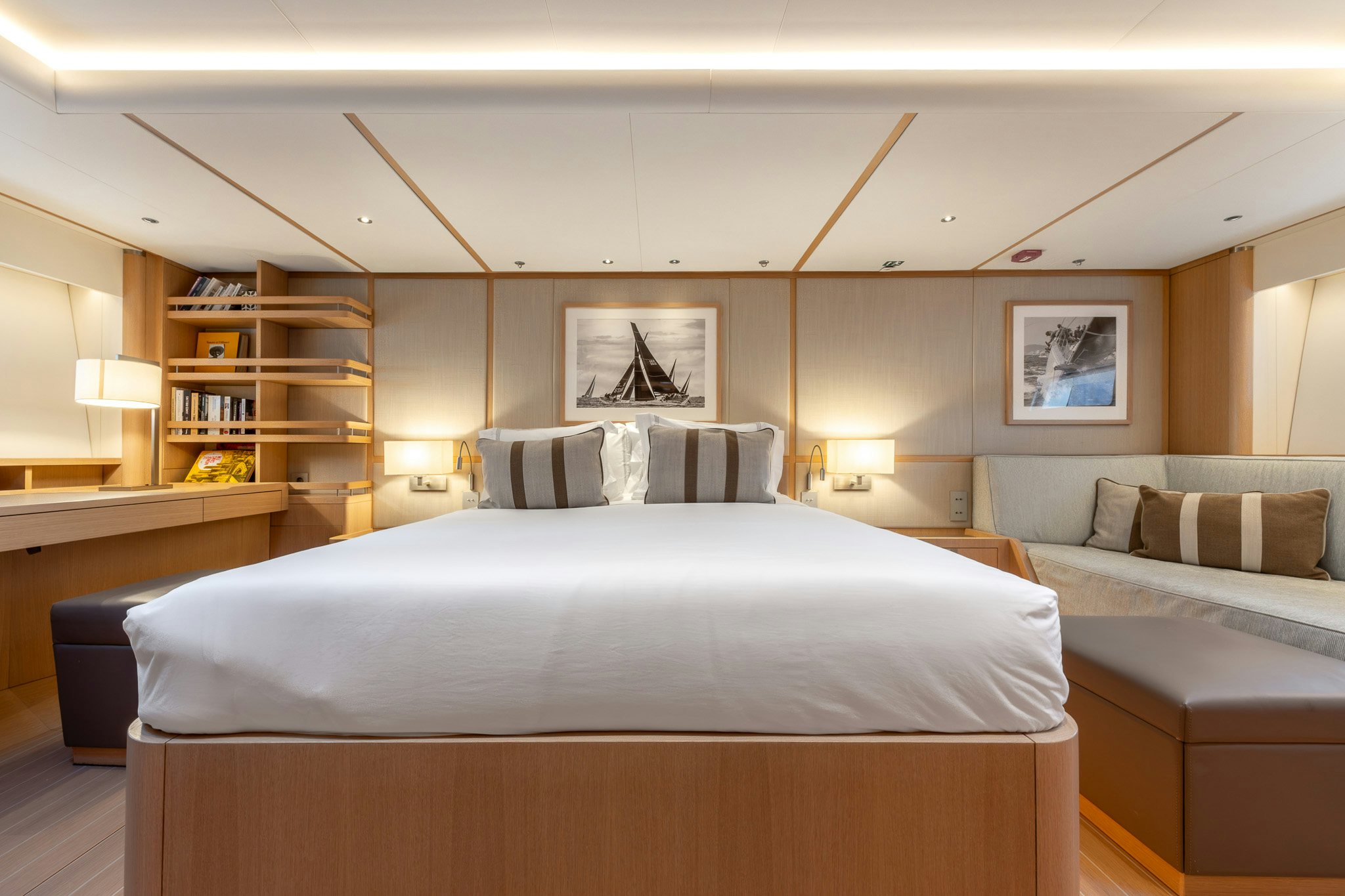 a bedroom with a bed and a bookcase aboard ALIX Yacht for Sale