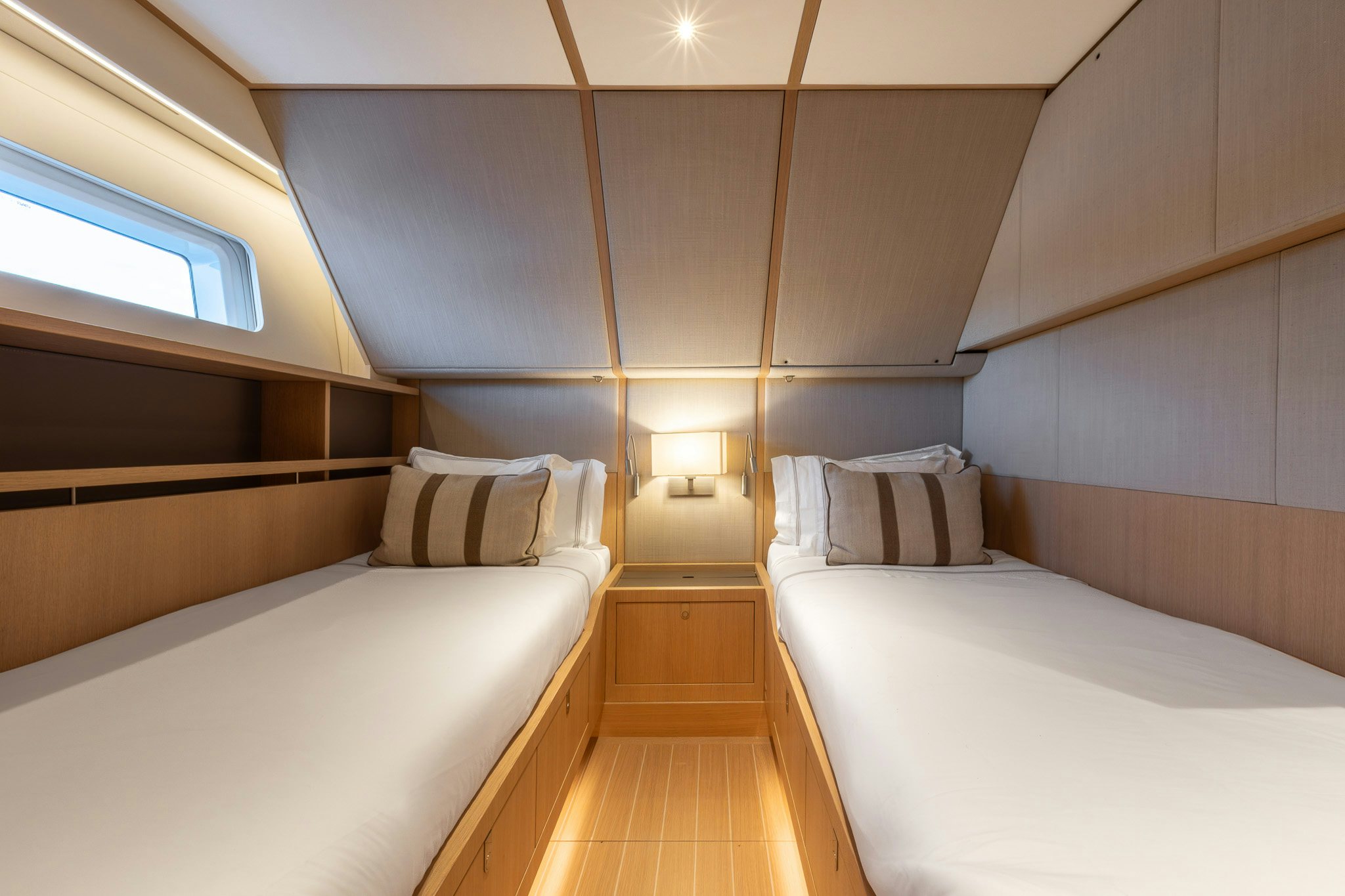 a room with beds and a wood floor aboard ALIX Yacht for Sale