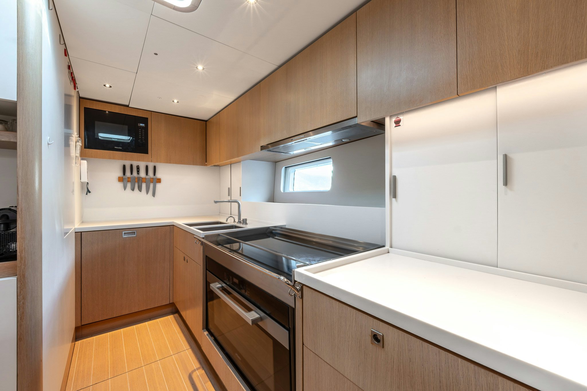 a kitchen with white cabinets aboard ALIX Yacht for Sale