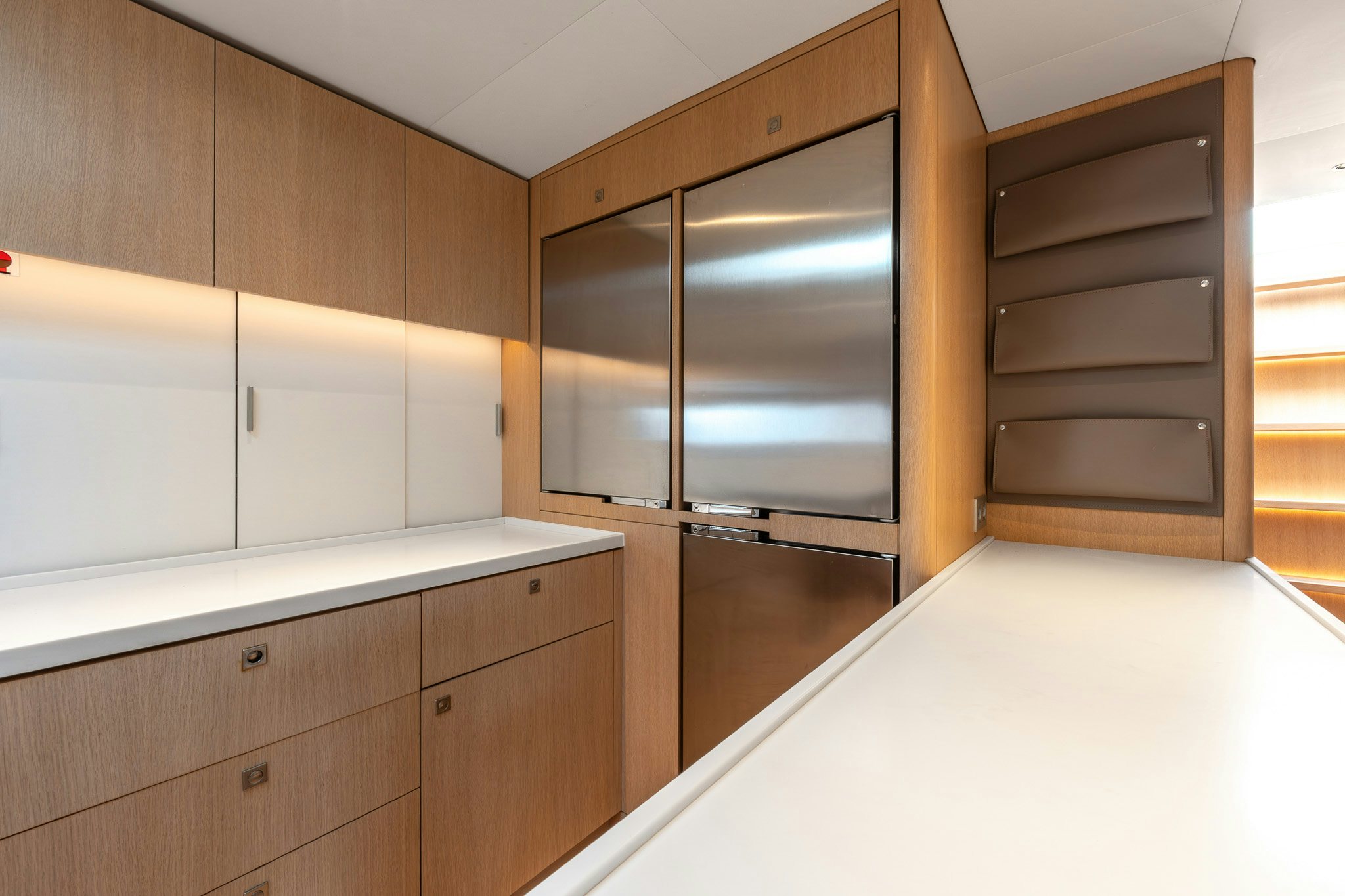 a kitchen with white cabinets aboard ALIX Yacht for Sale