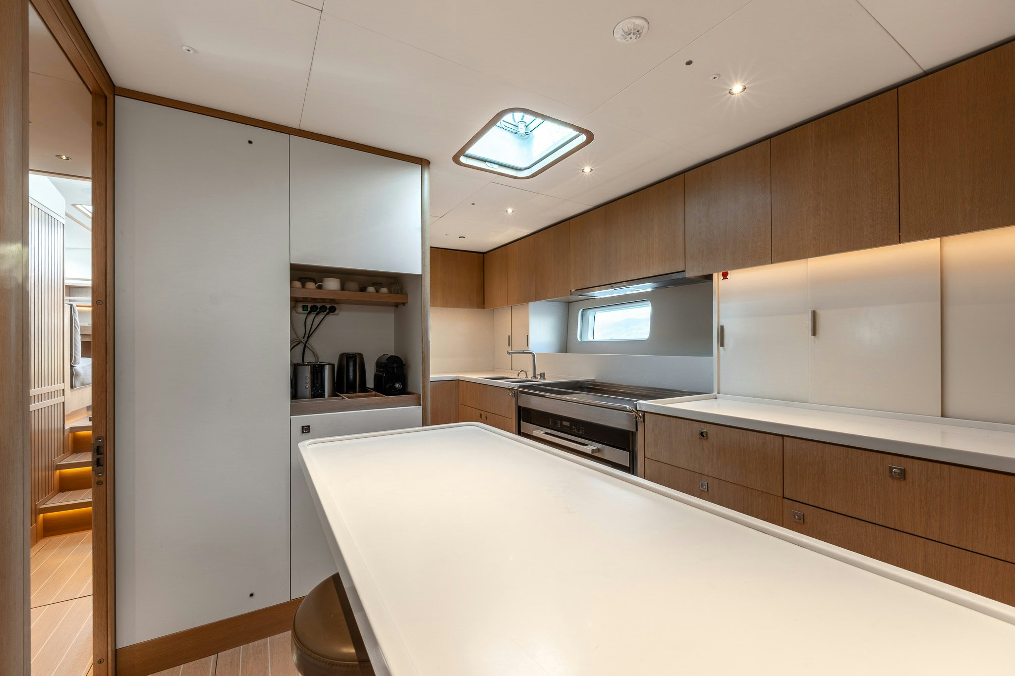 a kitchen with white cabinets aboard ALIX Yacht for Sale