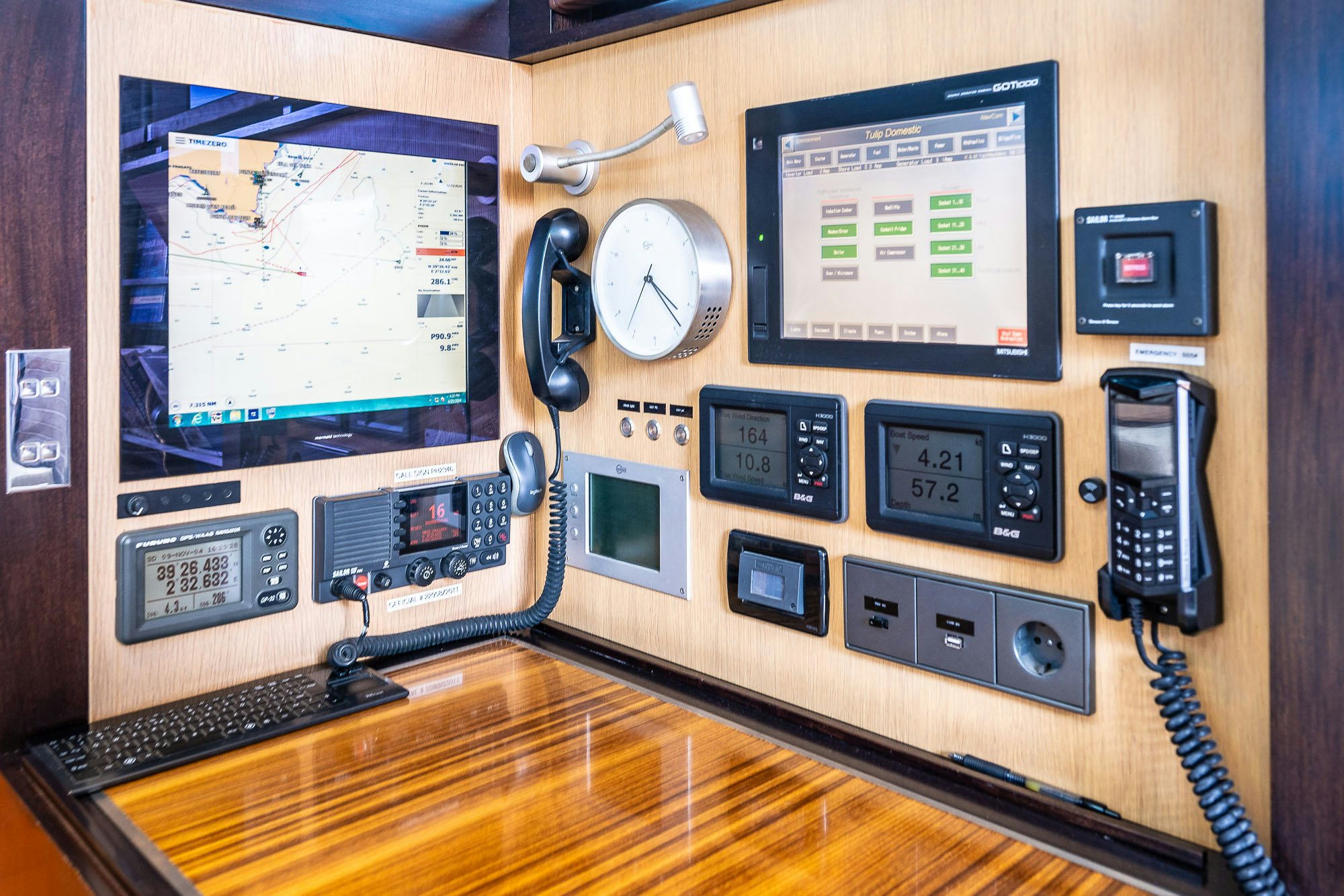 a computer desk with a few electronic devices aboard TULIP Yacht for Sale