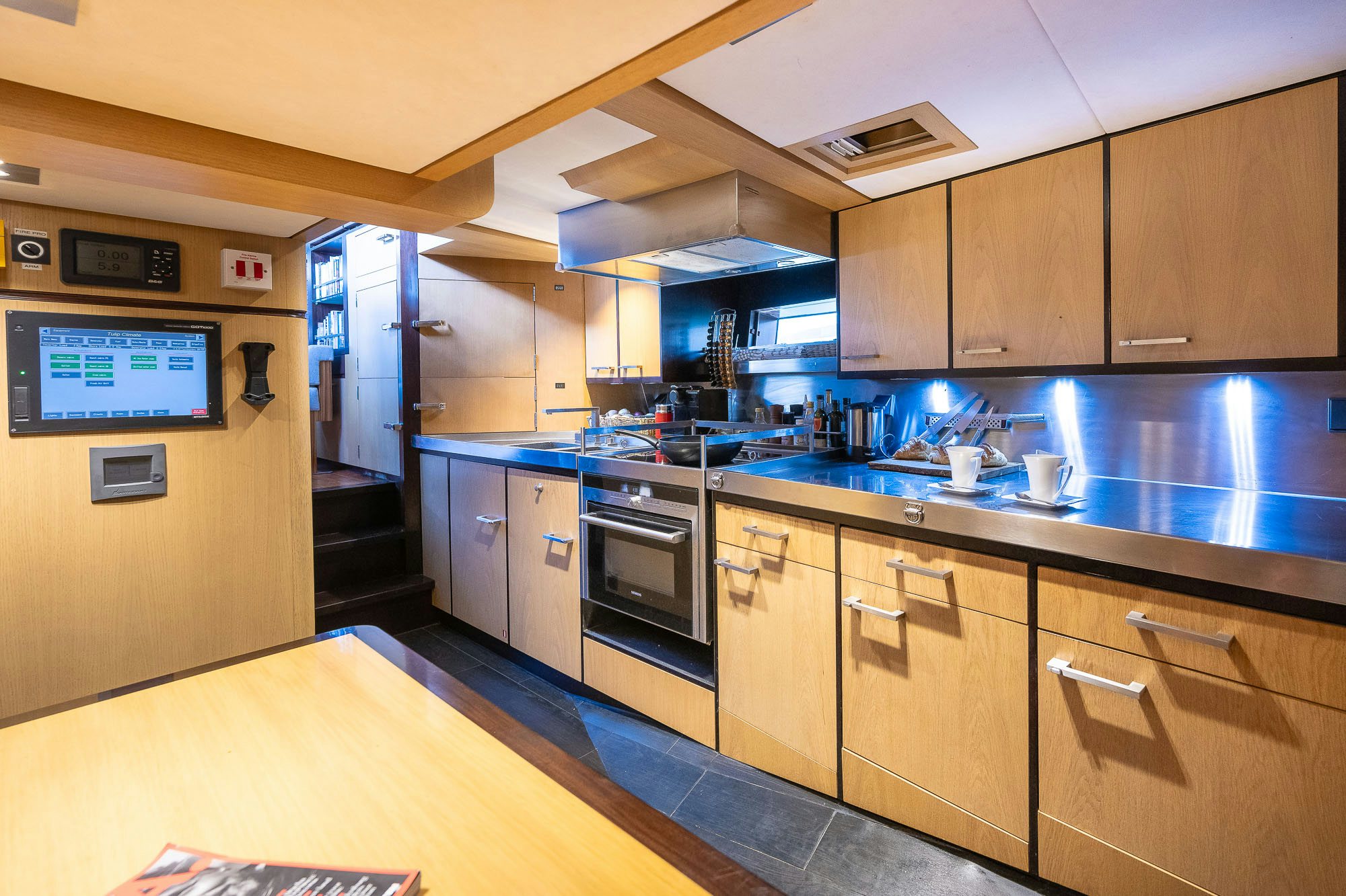 a kitchen with wooden cabinets aboard TULIP Yacht for Sale