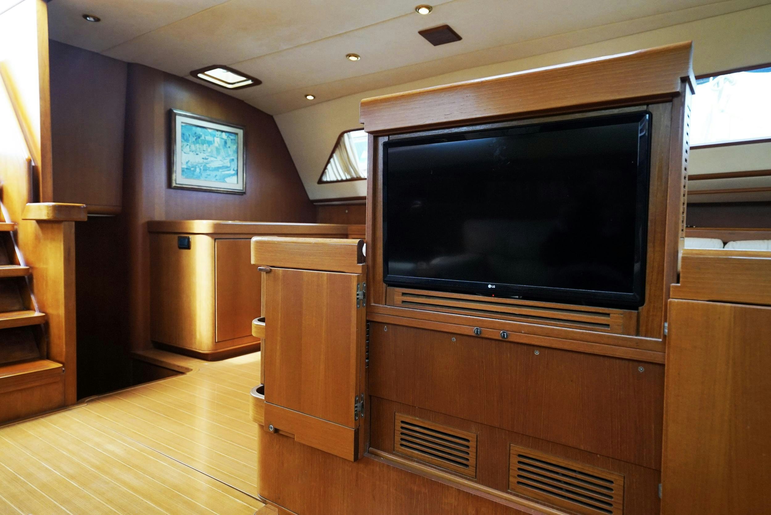 a tv on a cabinet in a room aboard GIBIAN Yacht for Sale