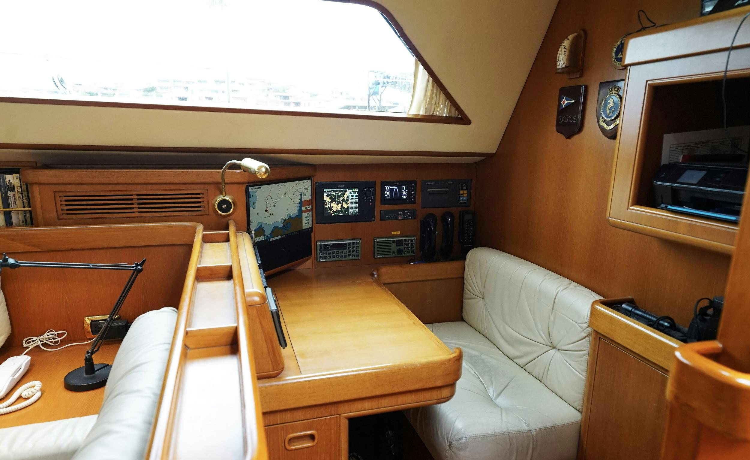 a room with a table and chairs aboard GIBIAN Yacht for Sale