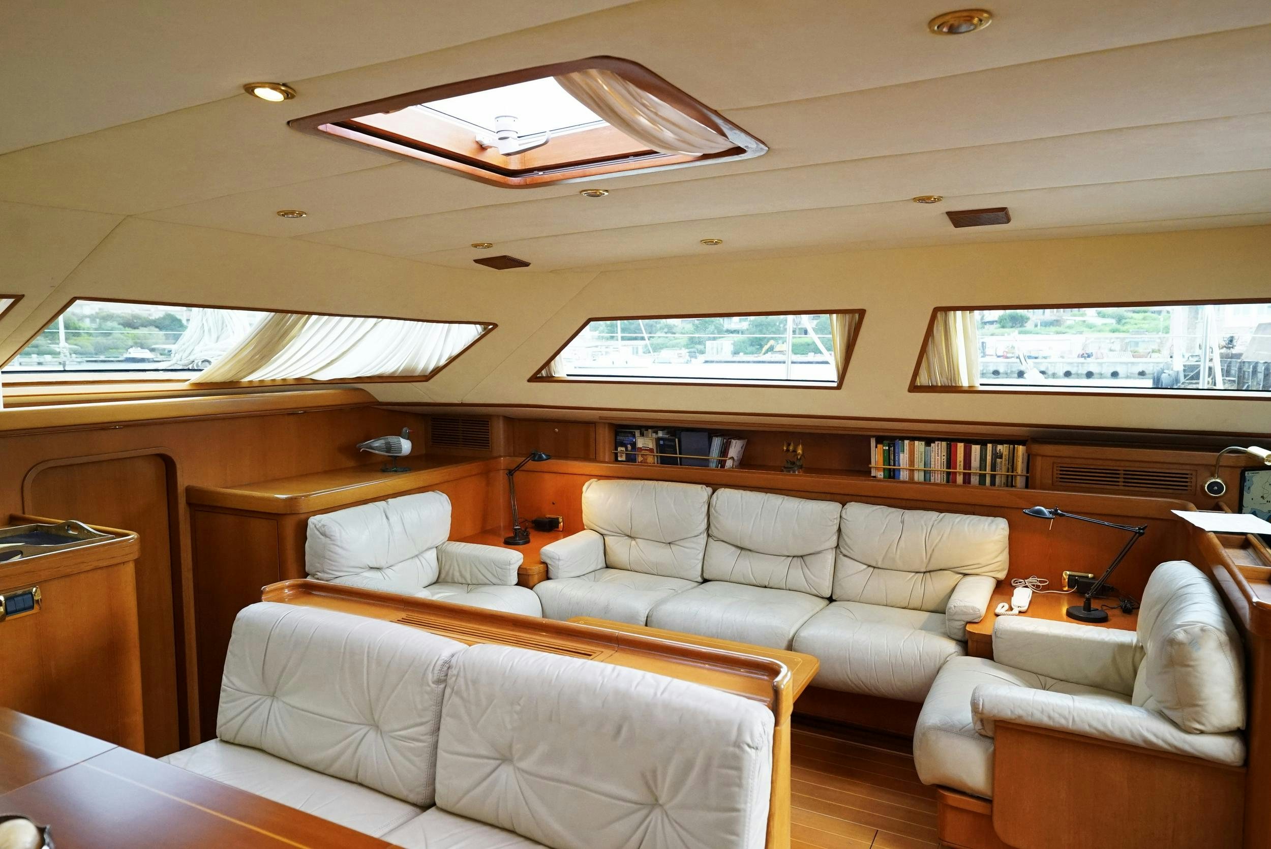 a living room with a couch and a table aboard GIBIAN Yacht for Sale