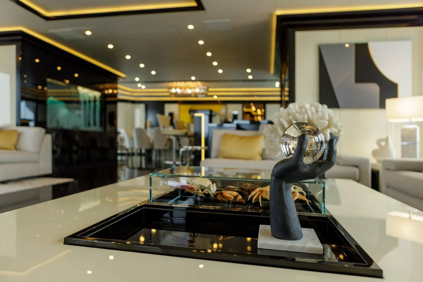 a large glass display case with a large silver ball in it aboard SAPPHIRE Yacht for Charter