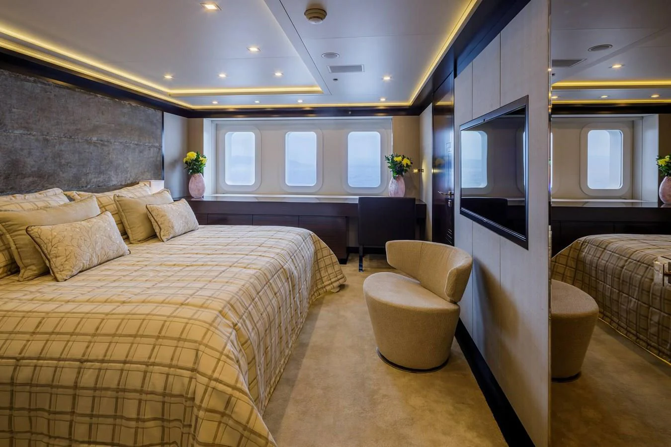 a bedroom with a bed and a chair aboard SAPPHIRE Yacht for Charter