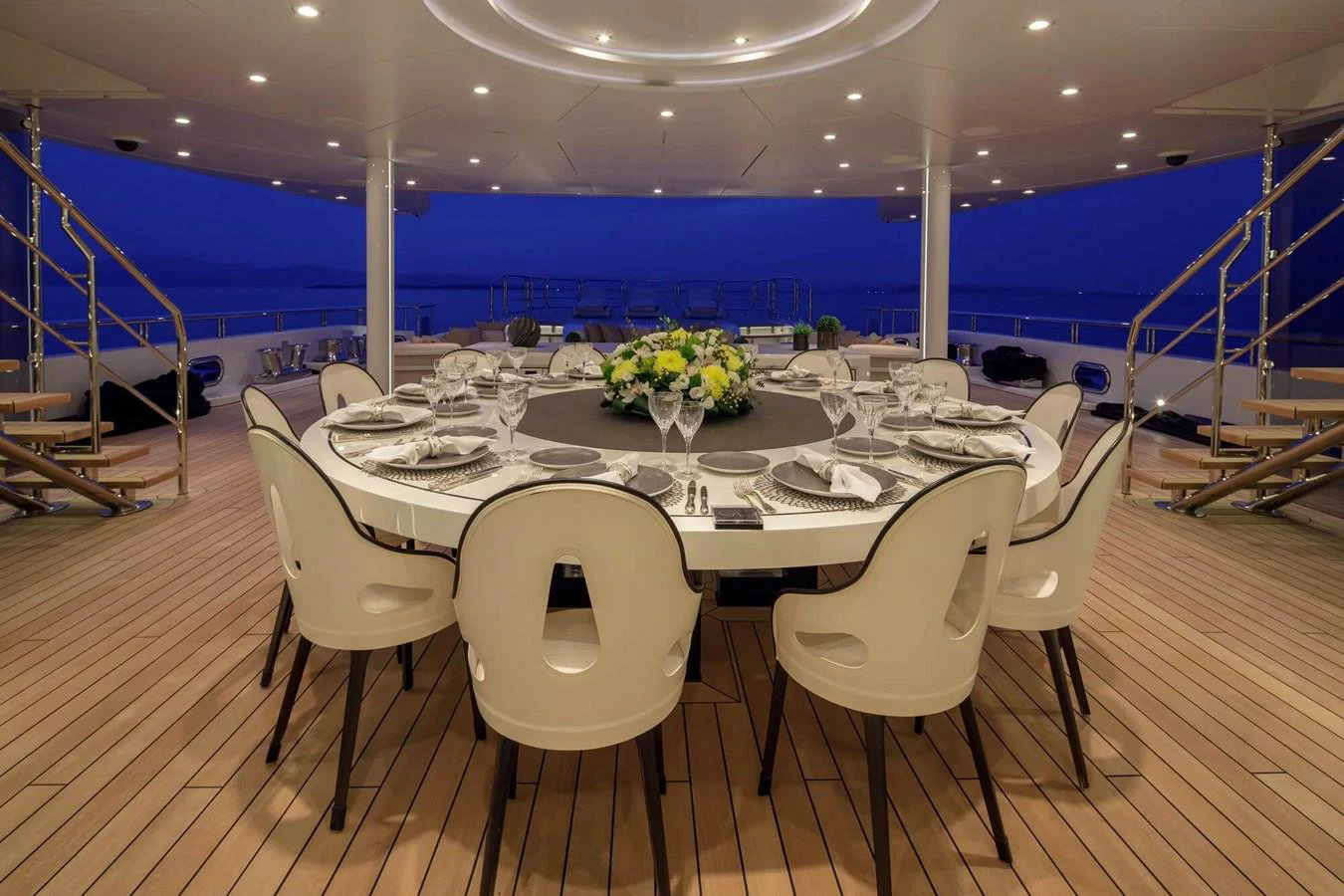 a table with chairs and a large window overlooking a large blue ocean aboard SAPPHIRE Yacht for Charter