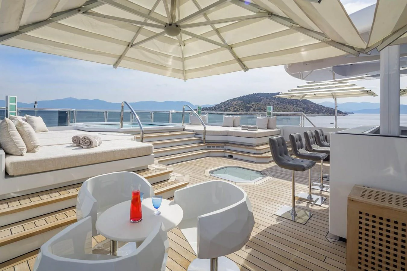 a room with a bed and chairs aboard SAPPHIRE Yacht for Charter