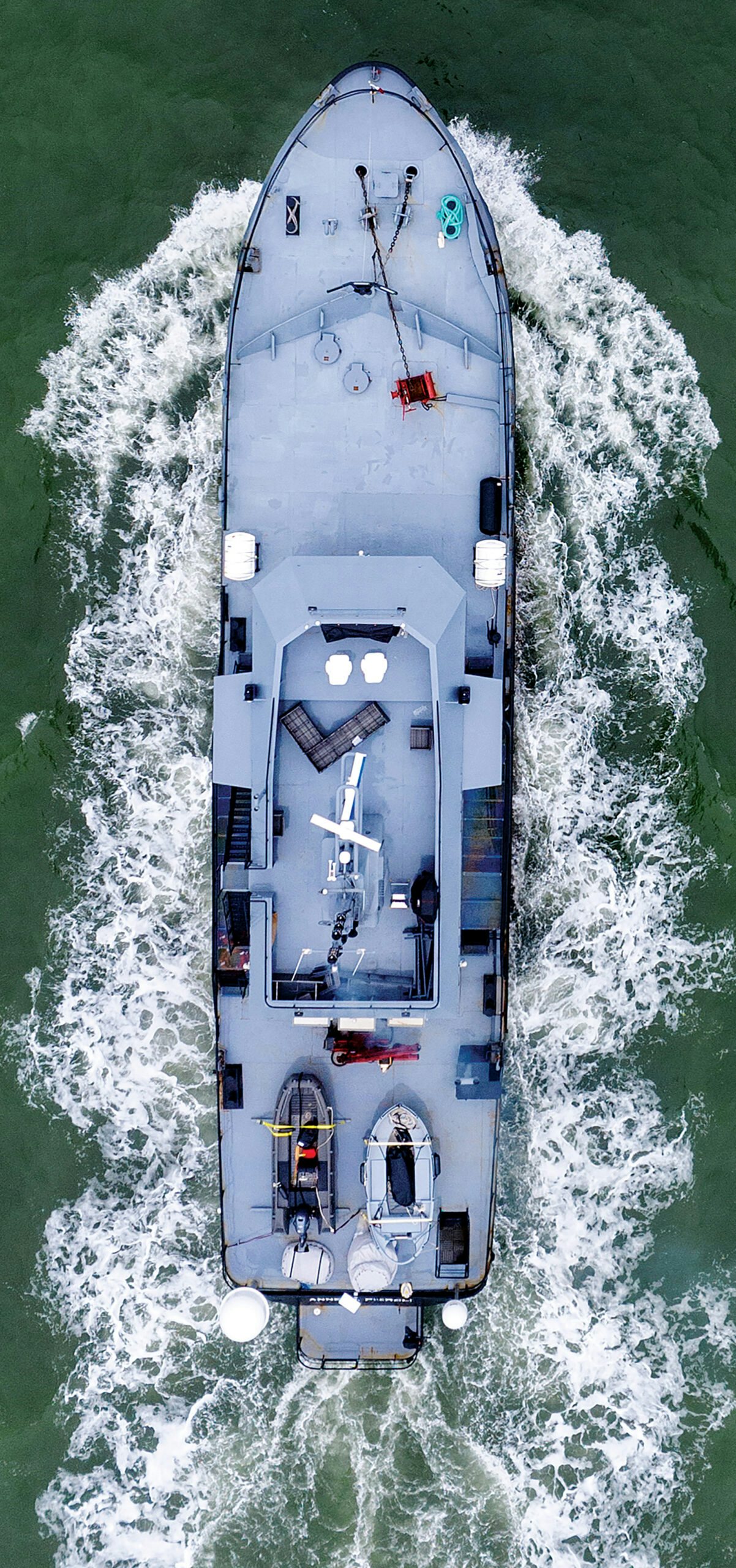 a white boat with a silver ship on it aboard ANNE S PIERCE Yacht for Sale