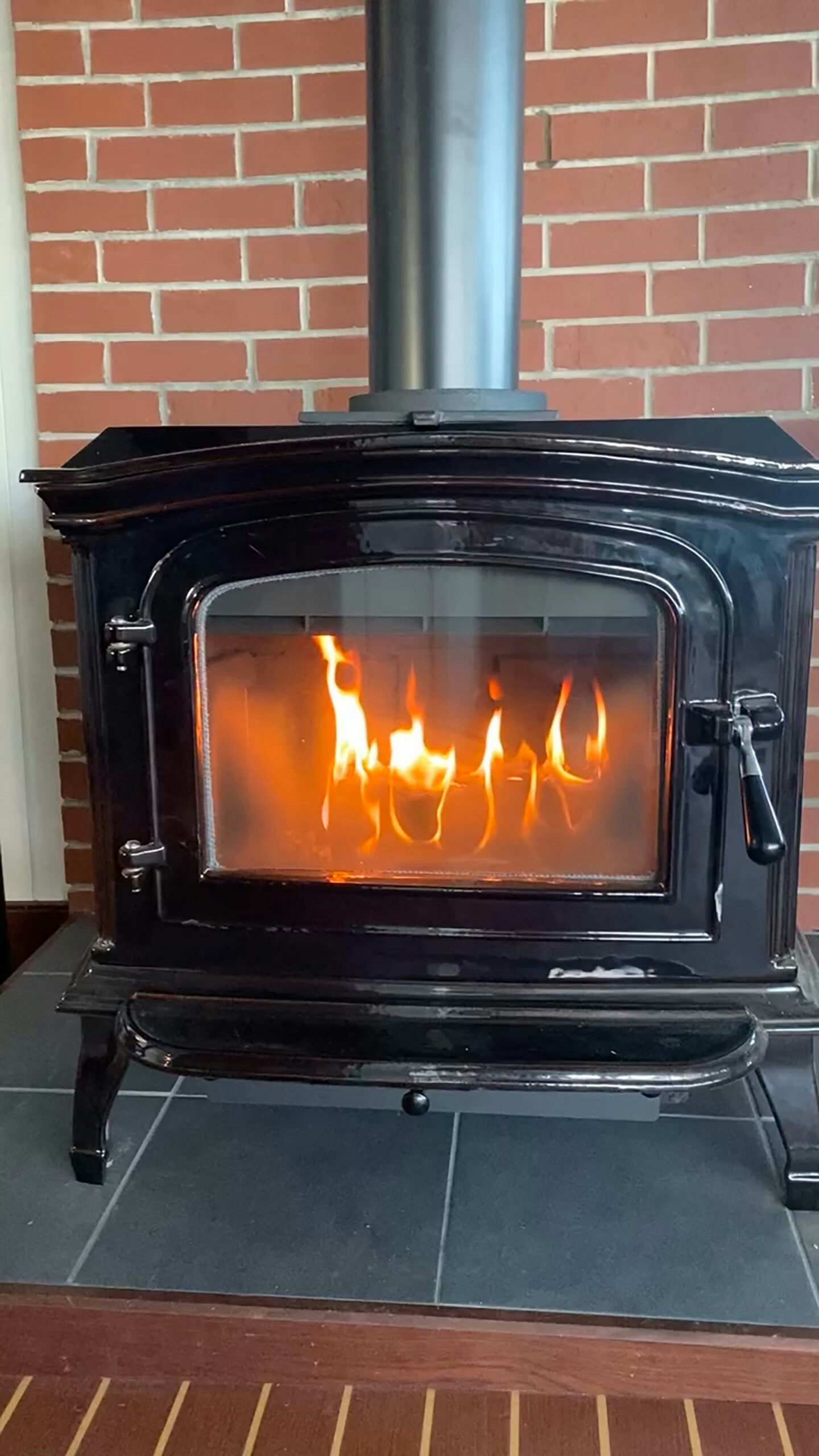 a wood stove with a fire inside aboard ANNE S PIERCE Yacht for Sale