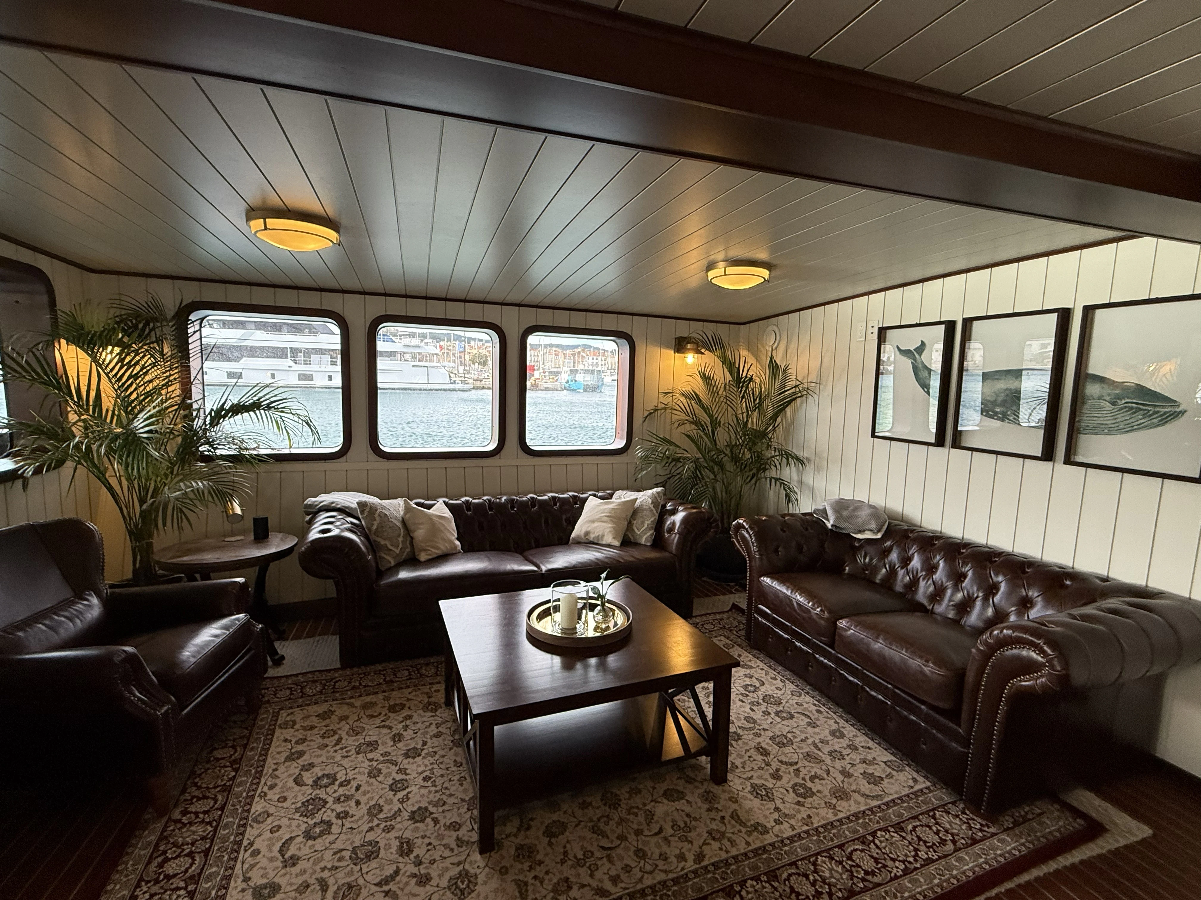 a living room with leather couches and a coffee table aboard ANNE S PIERCE Yacht for Sale