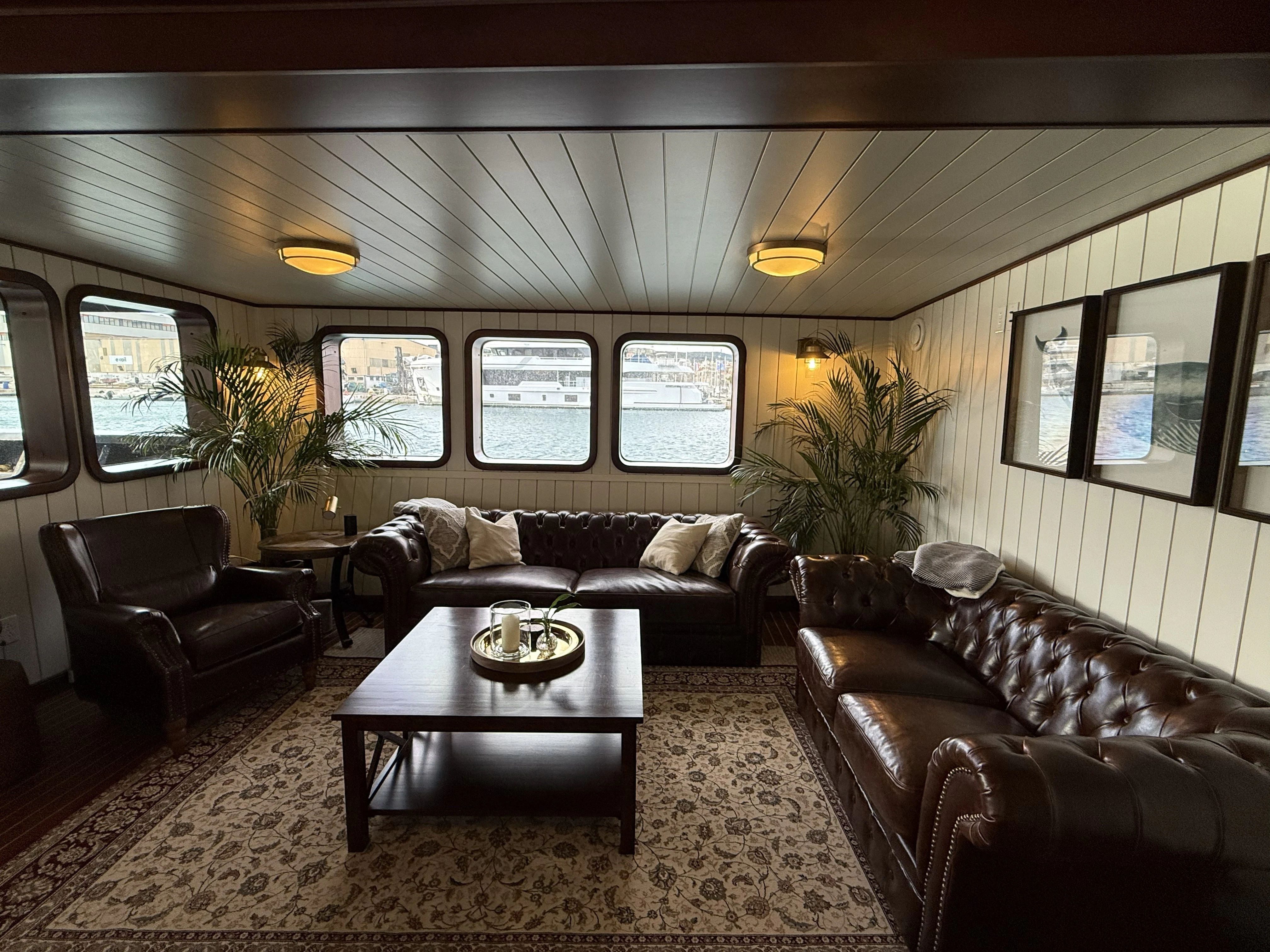 a living room with leather couches and a coffee table aboard ANNE S PIERCE Yacht for Sale