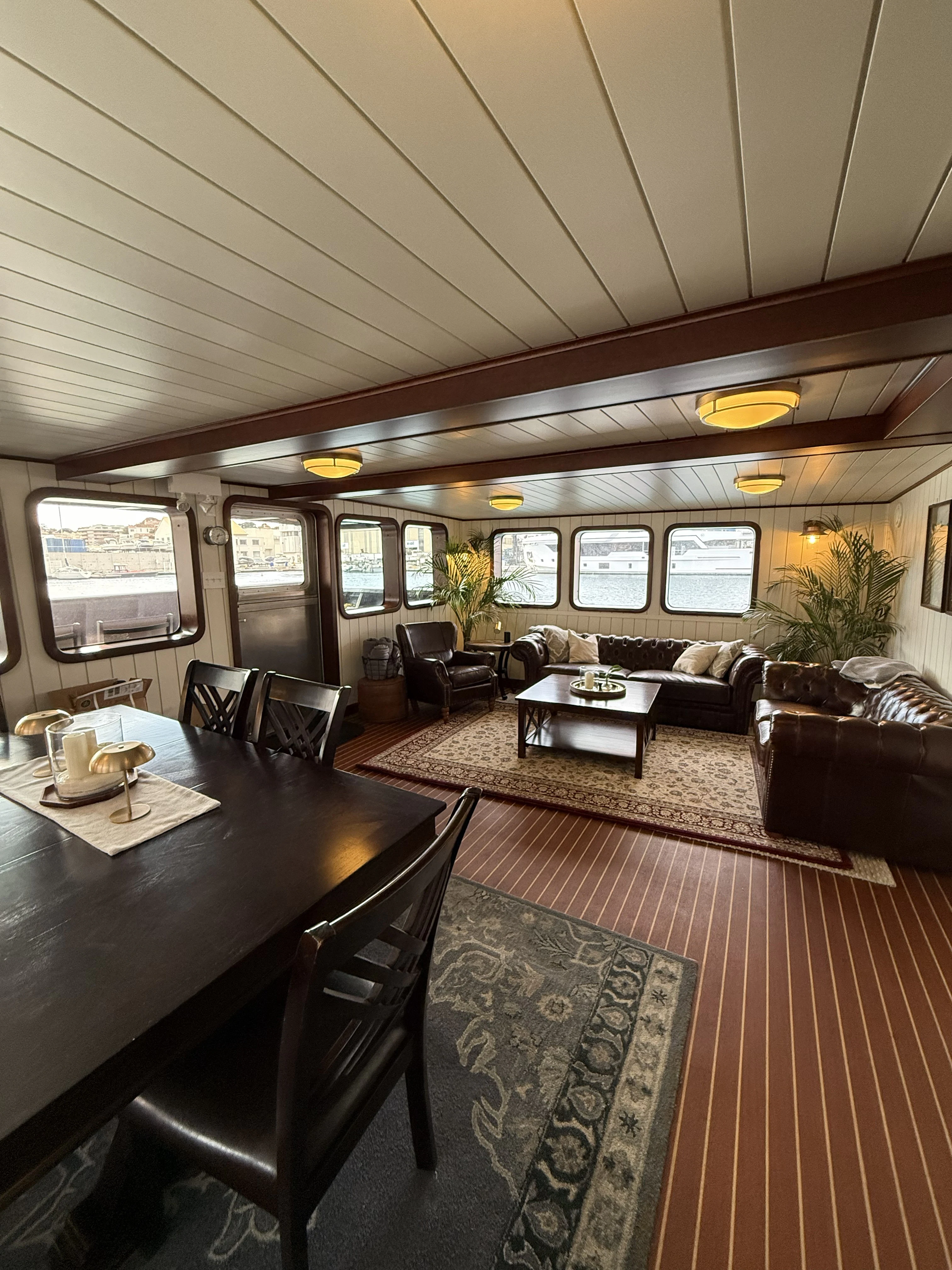 a large living room with a table and chairs aboard ANNE S PIERCE Yacht for Sale