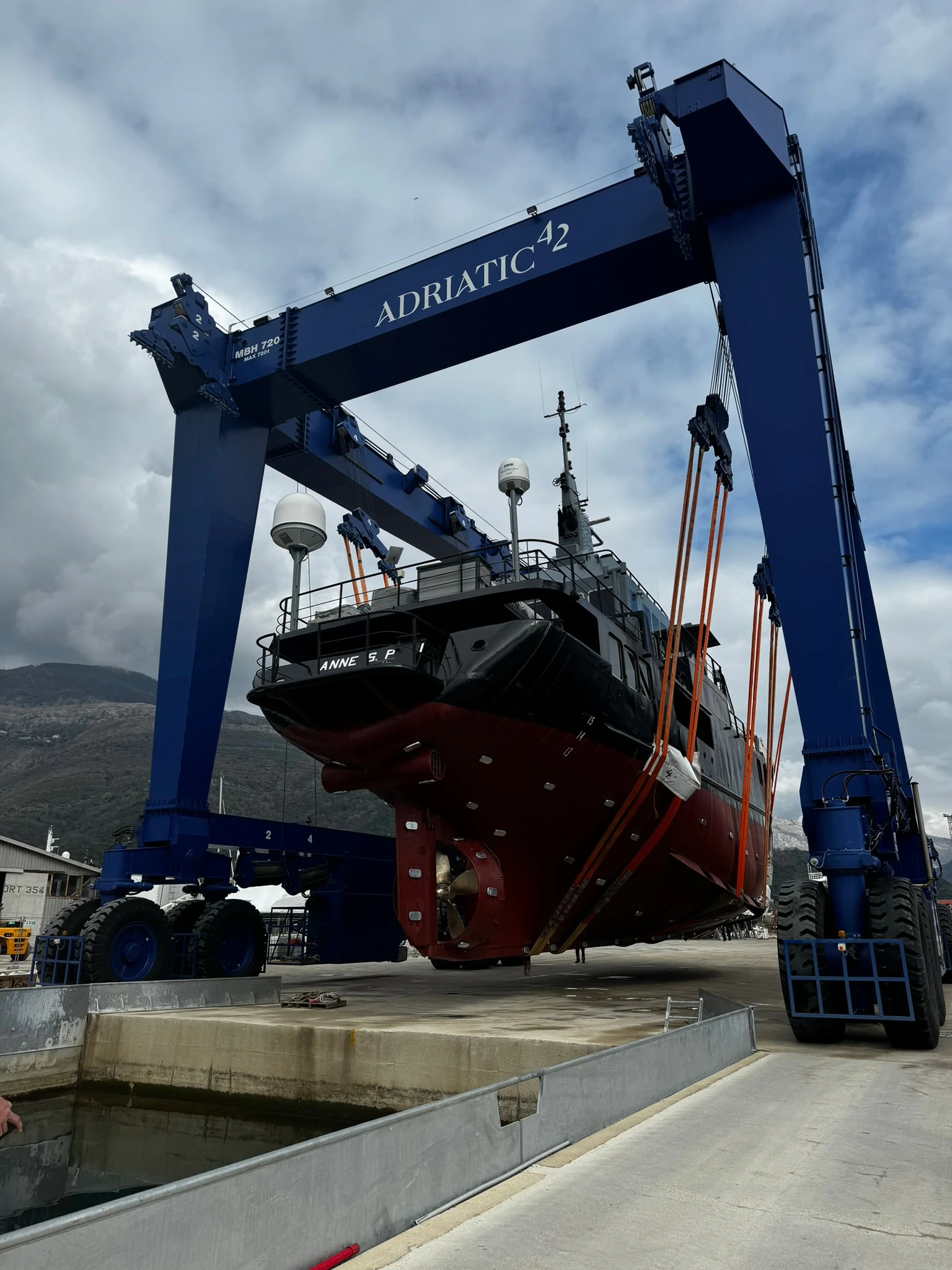 a large red boat with a blue crane on it aboard ANNE S PIERCE Yacht for Sale
