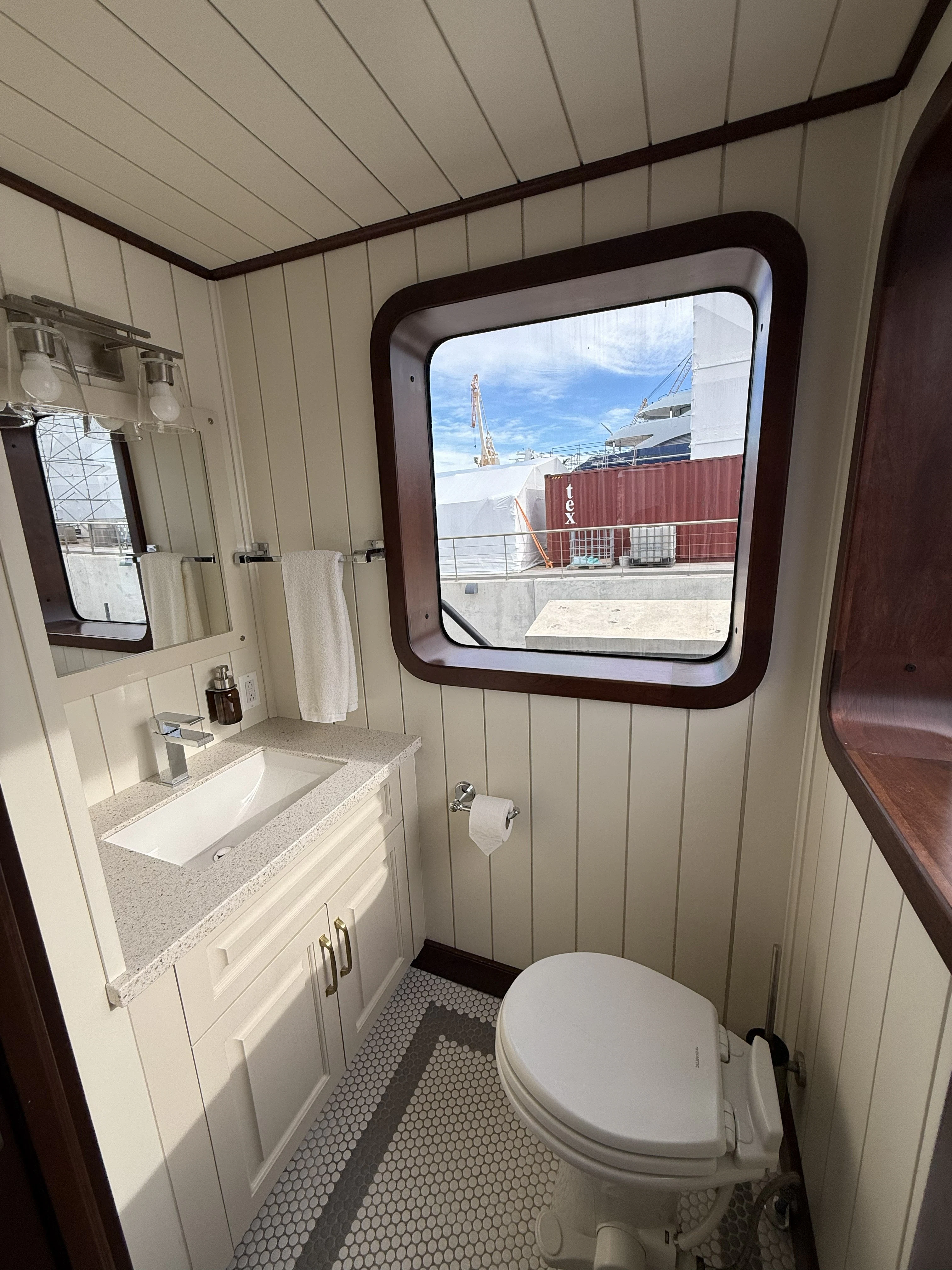 a bathroom with a sink toilet and a window aboard ANNE S PIERCE Yacht for Sale
