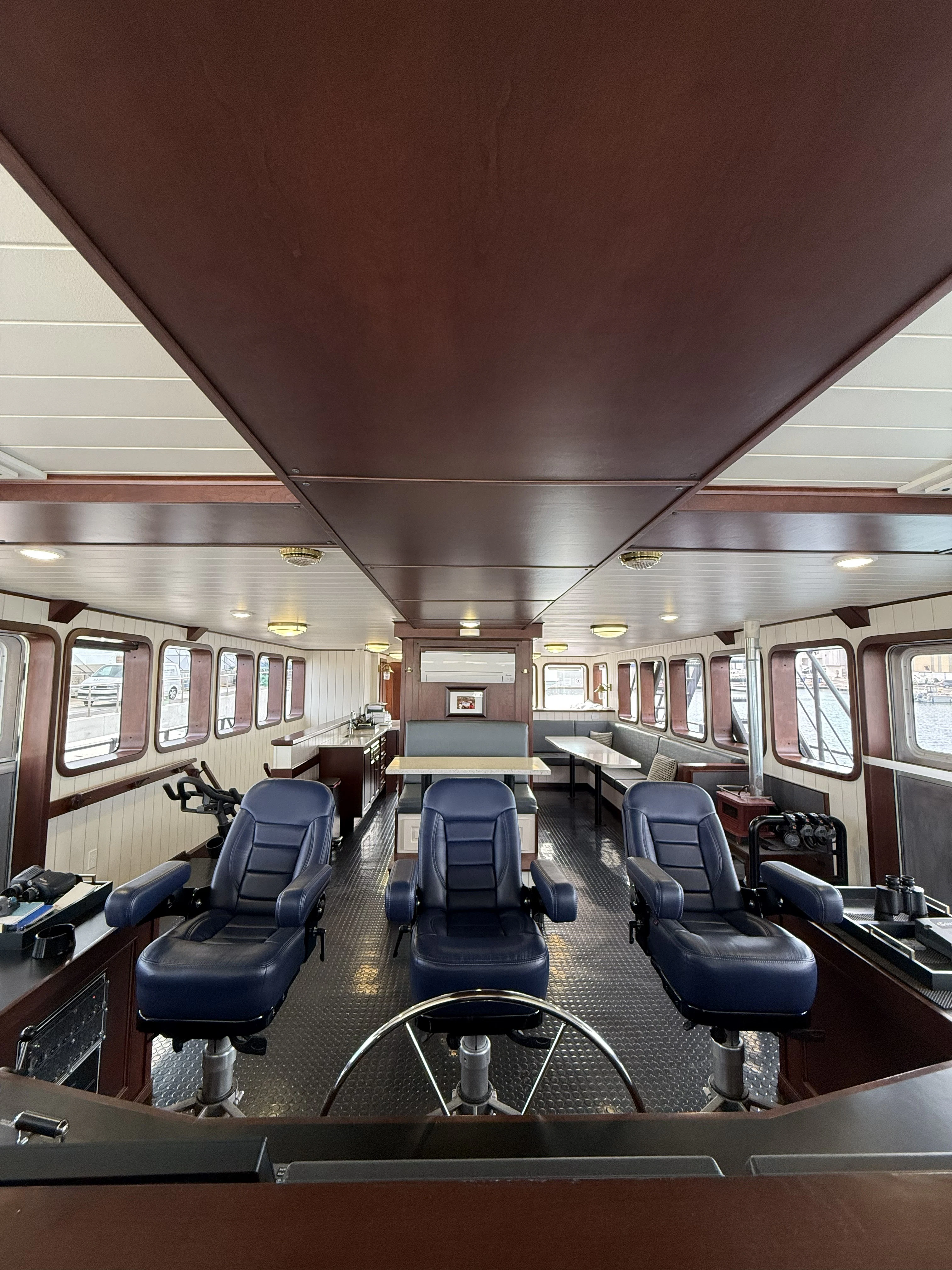 a room with a large table and chairs aboard ANNE S PIERCE Yacht for Sale