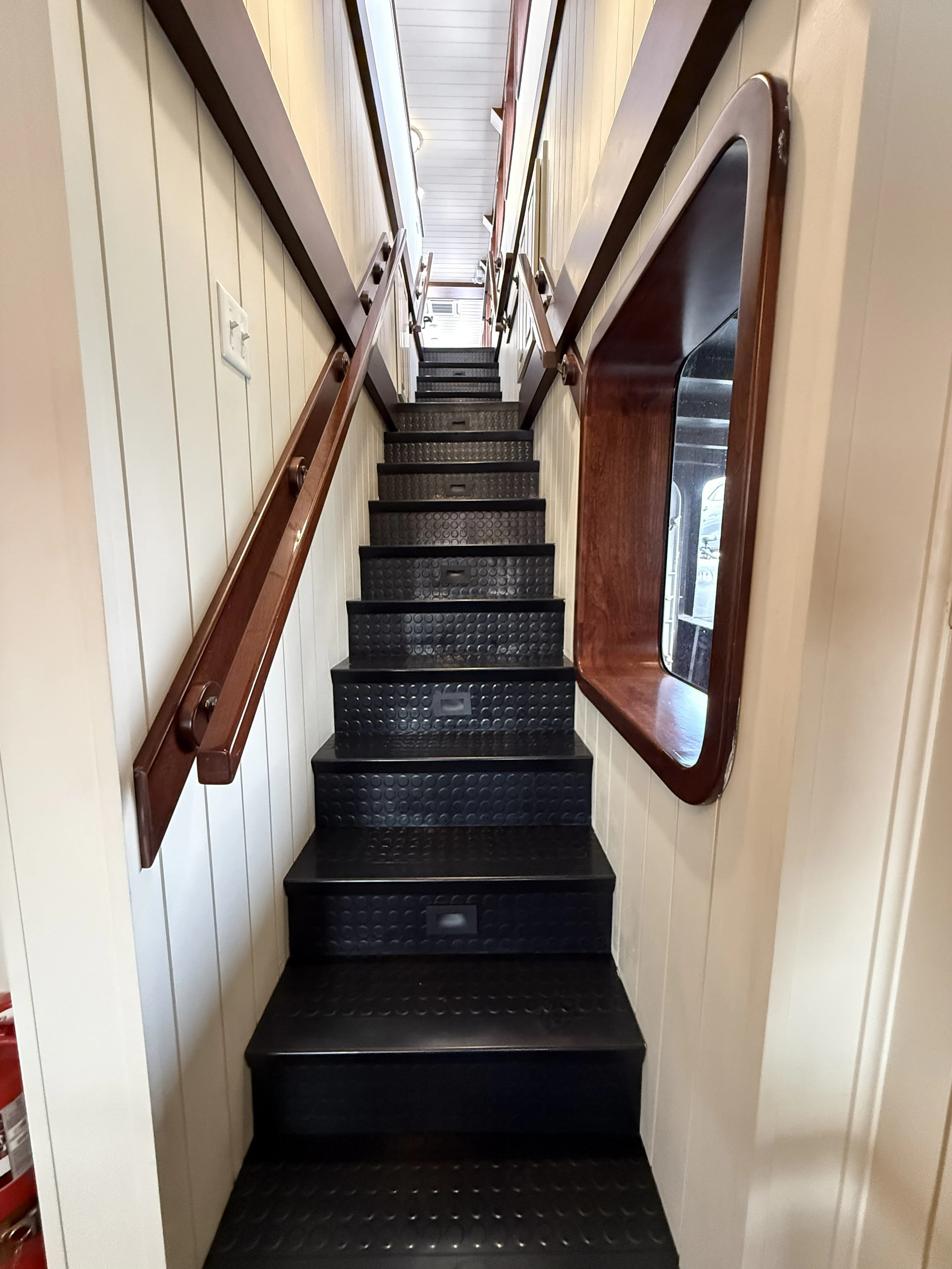 a staircase with a window aboard ANNE S PIERCE Yacht for Sale