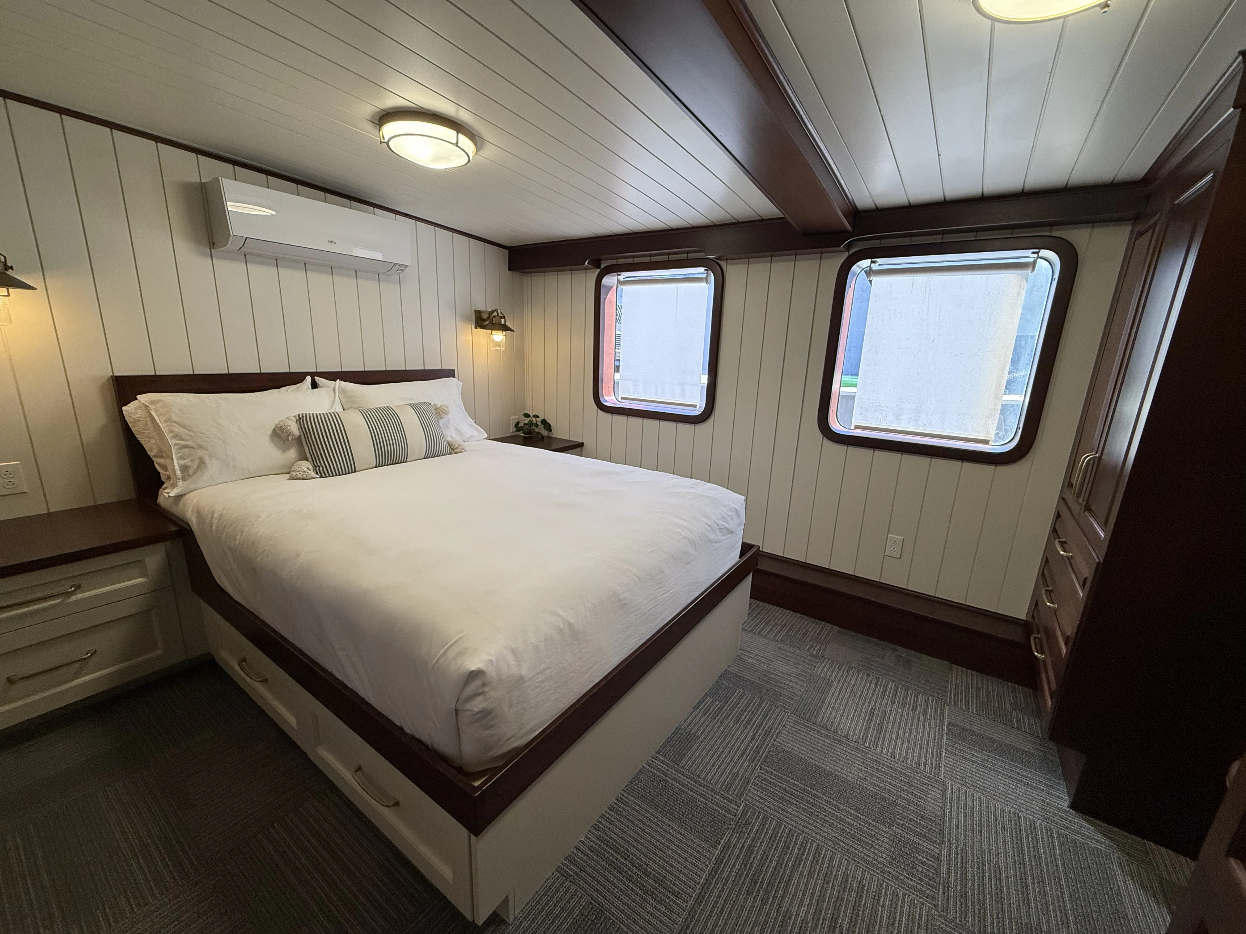 a bedroom with a bed and a window aboard ANNE S PIERCE Yacht for Sale