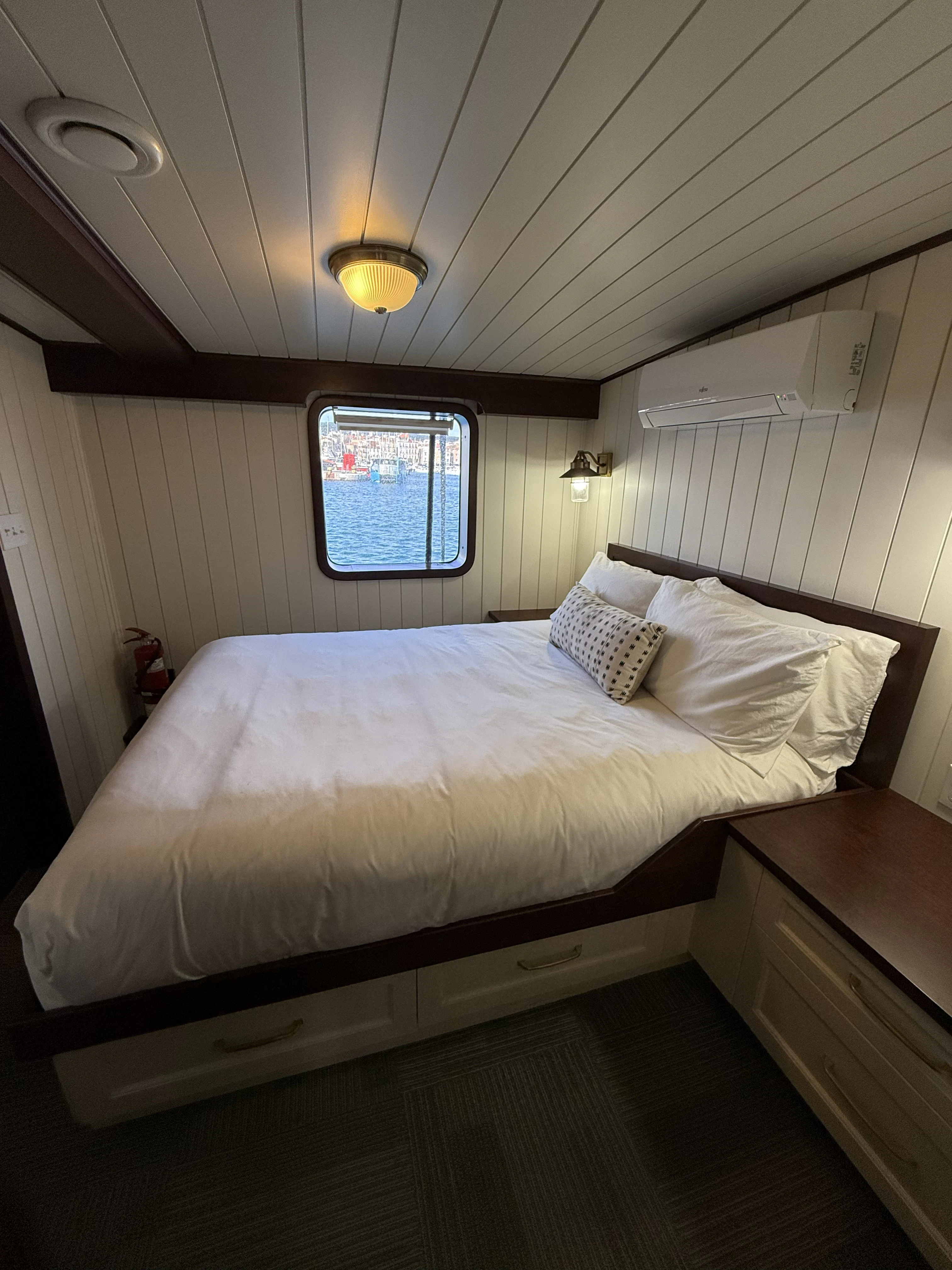 a bed with a white comforter aboard ANNE S PIERCE Yacht for Sale