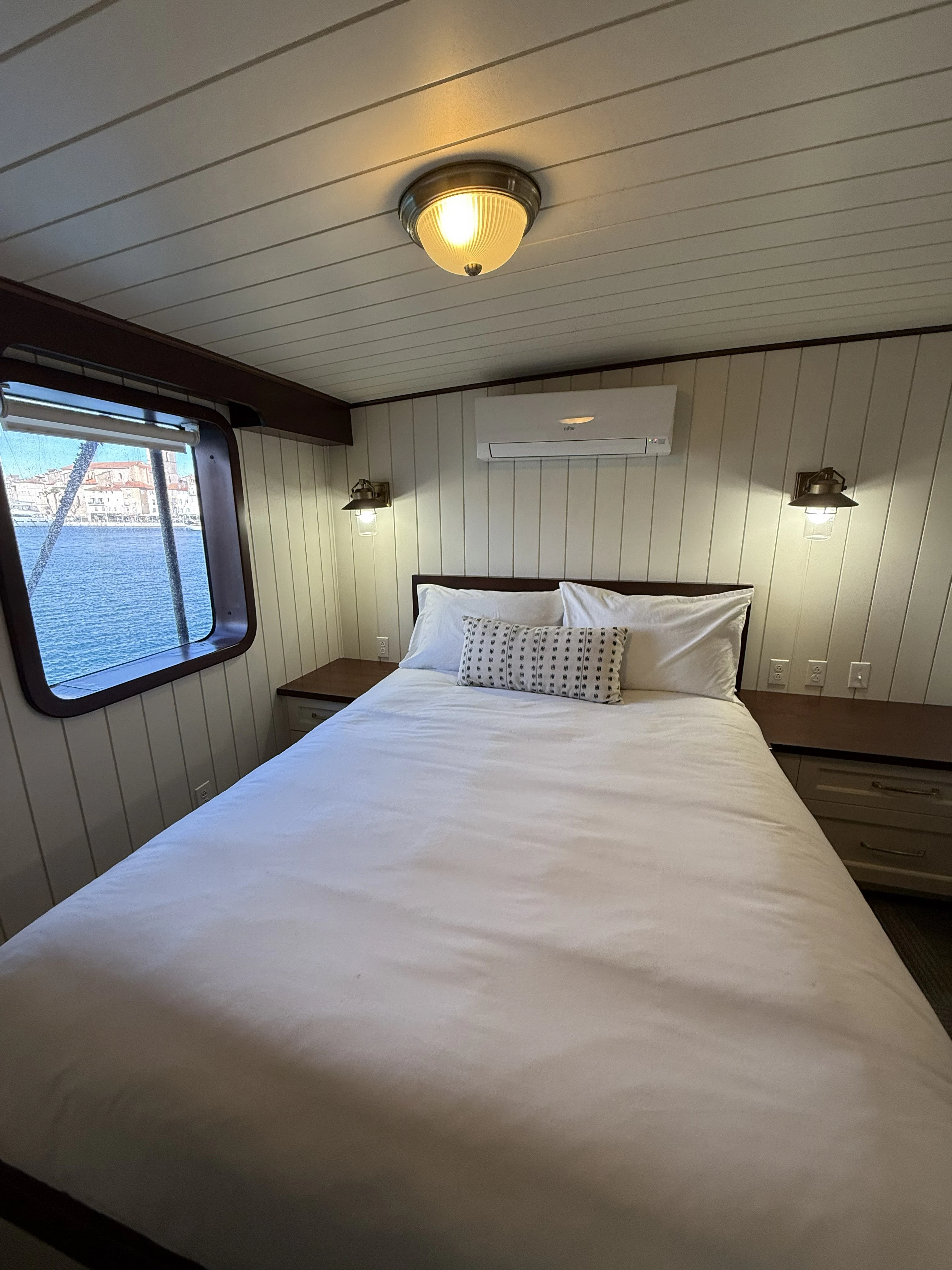 a bed with a white comforter aboard ANNE S PIERCE Yacht for Sale
