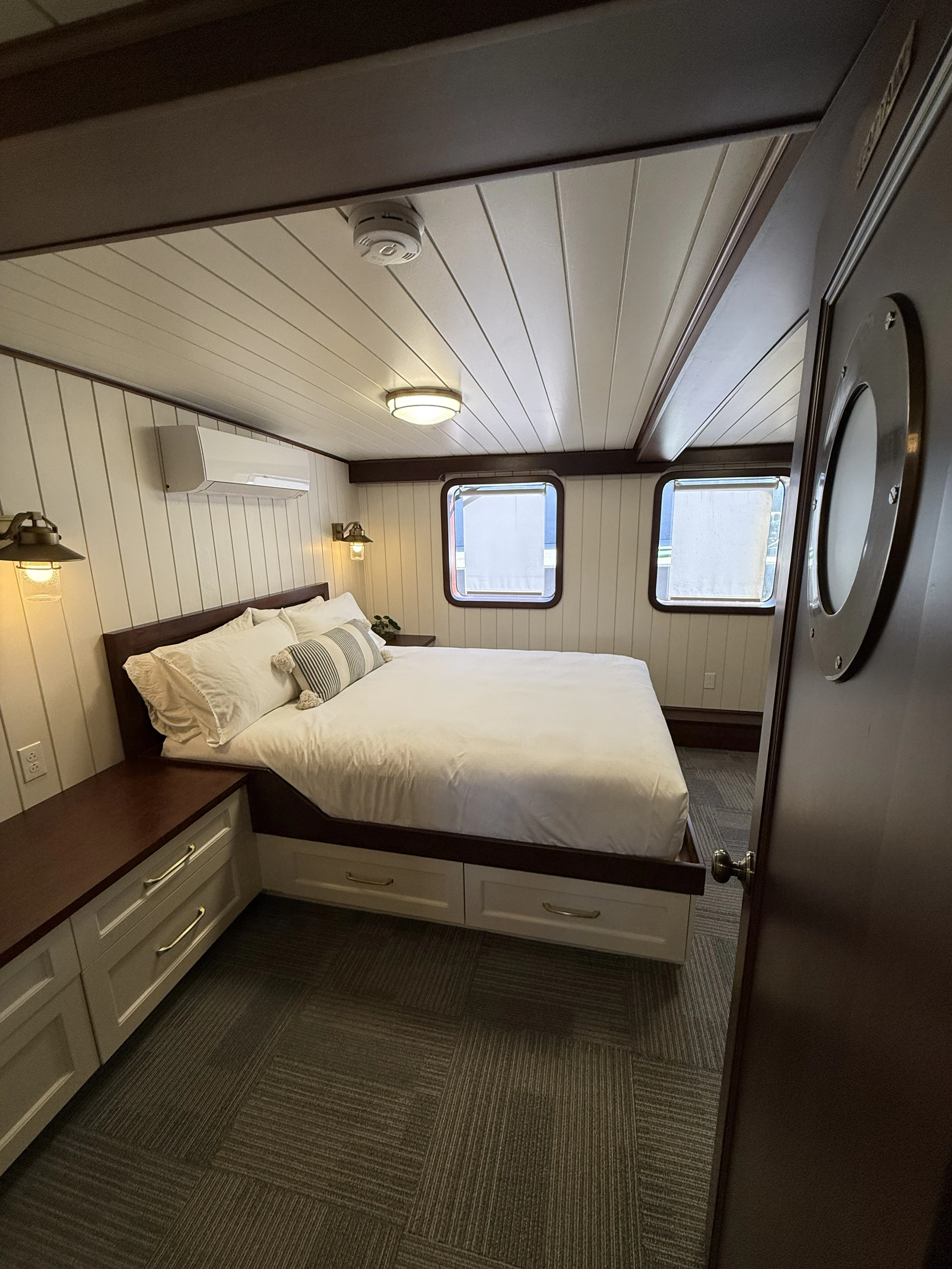 a bedroom with a bed and a mirror aboard ANNE S PIERCE Yacht for Sale