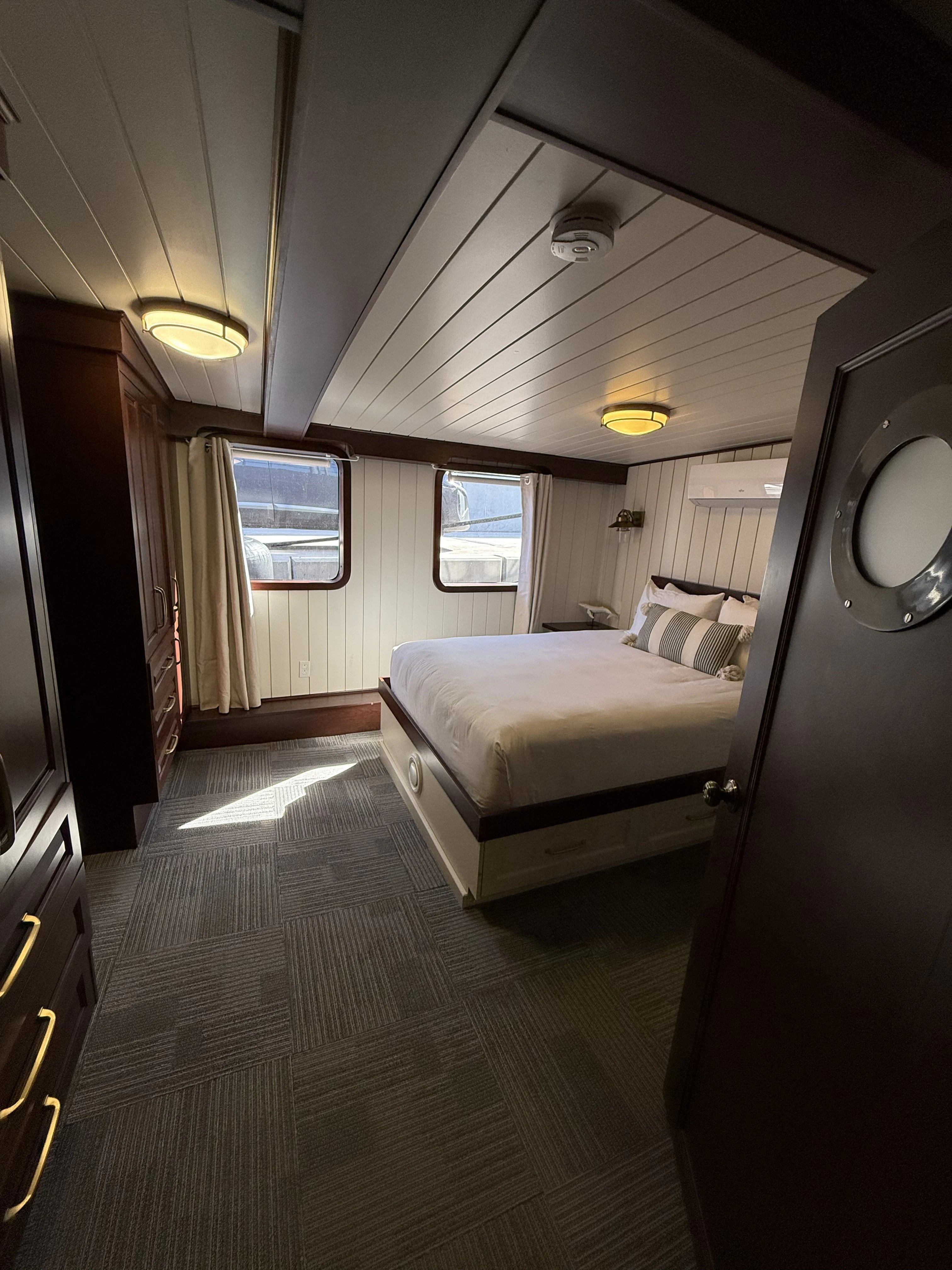 a bedroom with a bed and a window aboard ANNE S PIERCE Yacht for Sale