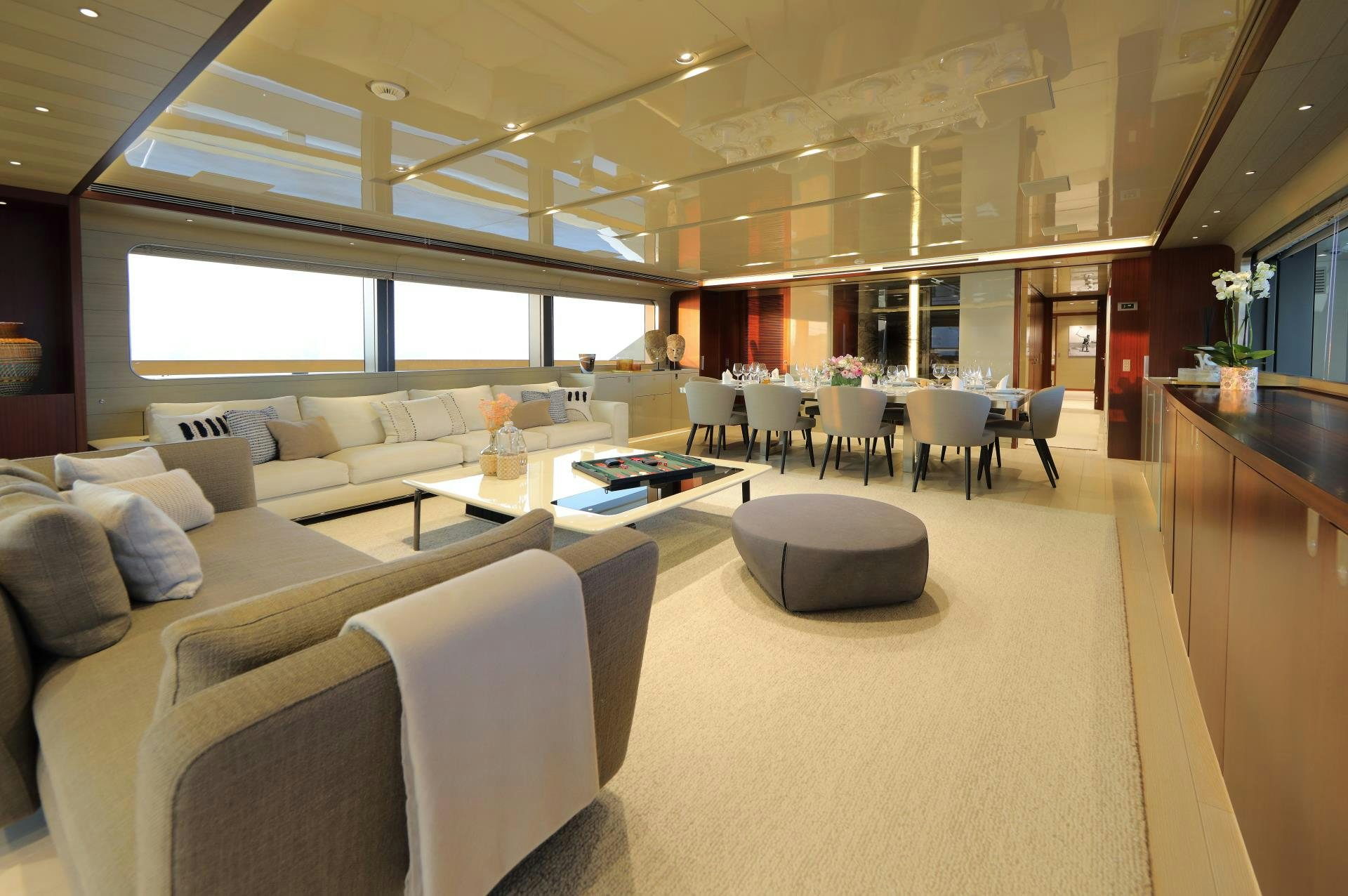 a living room with a couch and a table aboard X Yacht for Sale